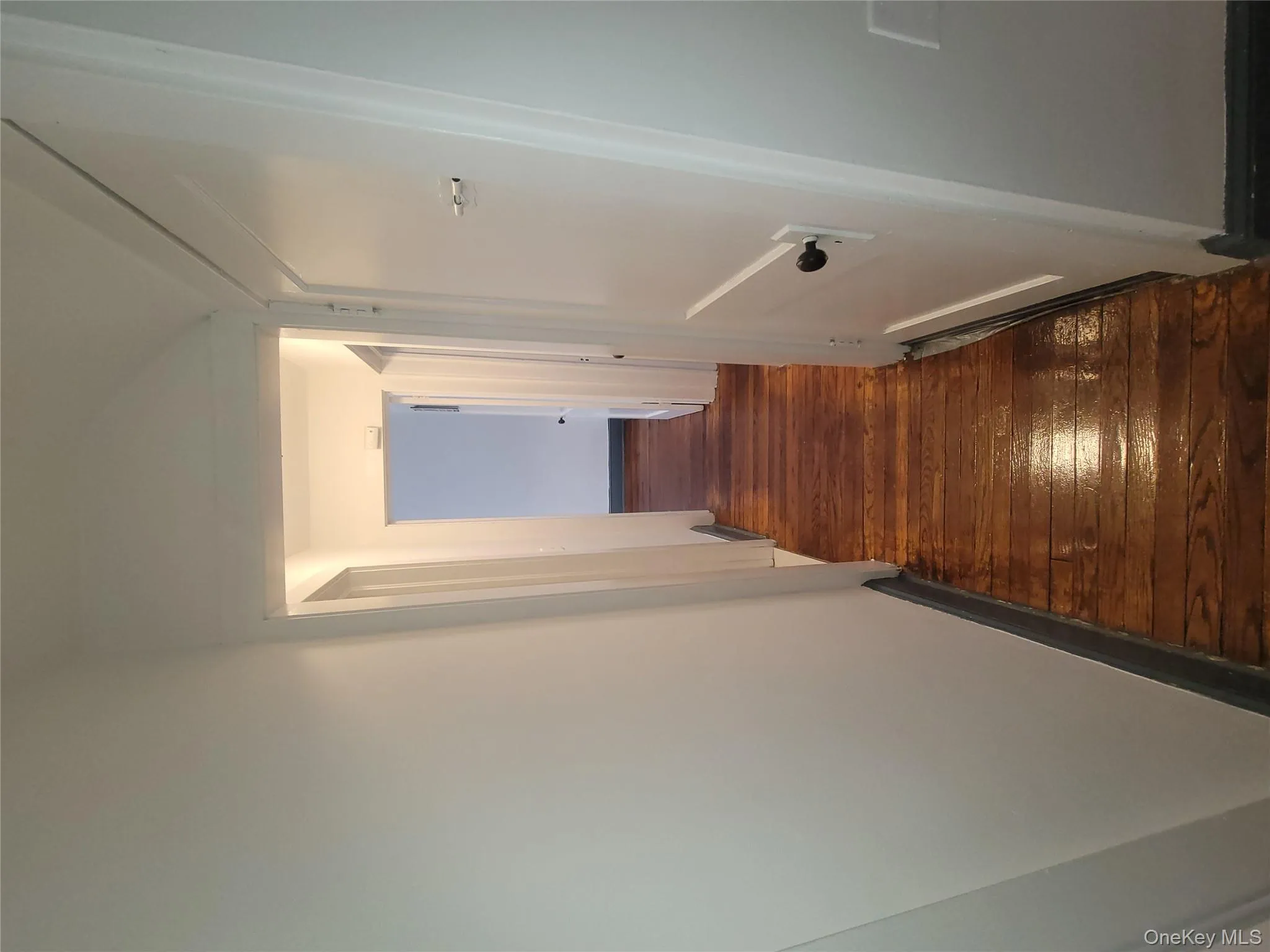 Corridor featuring dark wood-style flooring and baseboards Corridor featuring dark wood-style flooring and baseboards