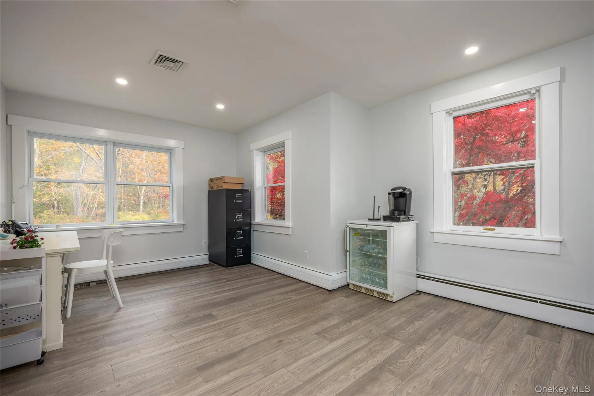 Private office with light wood-style flooring, recessed lighting, a baseboard radiator, and baseboard heating Private office with light wood-style flooring, recessed lighting, a baseboard radiator, and baseboard heating