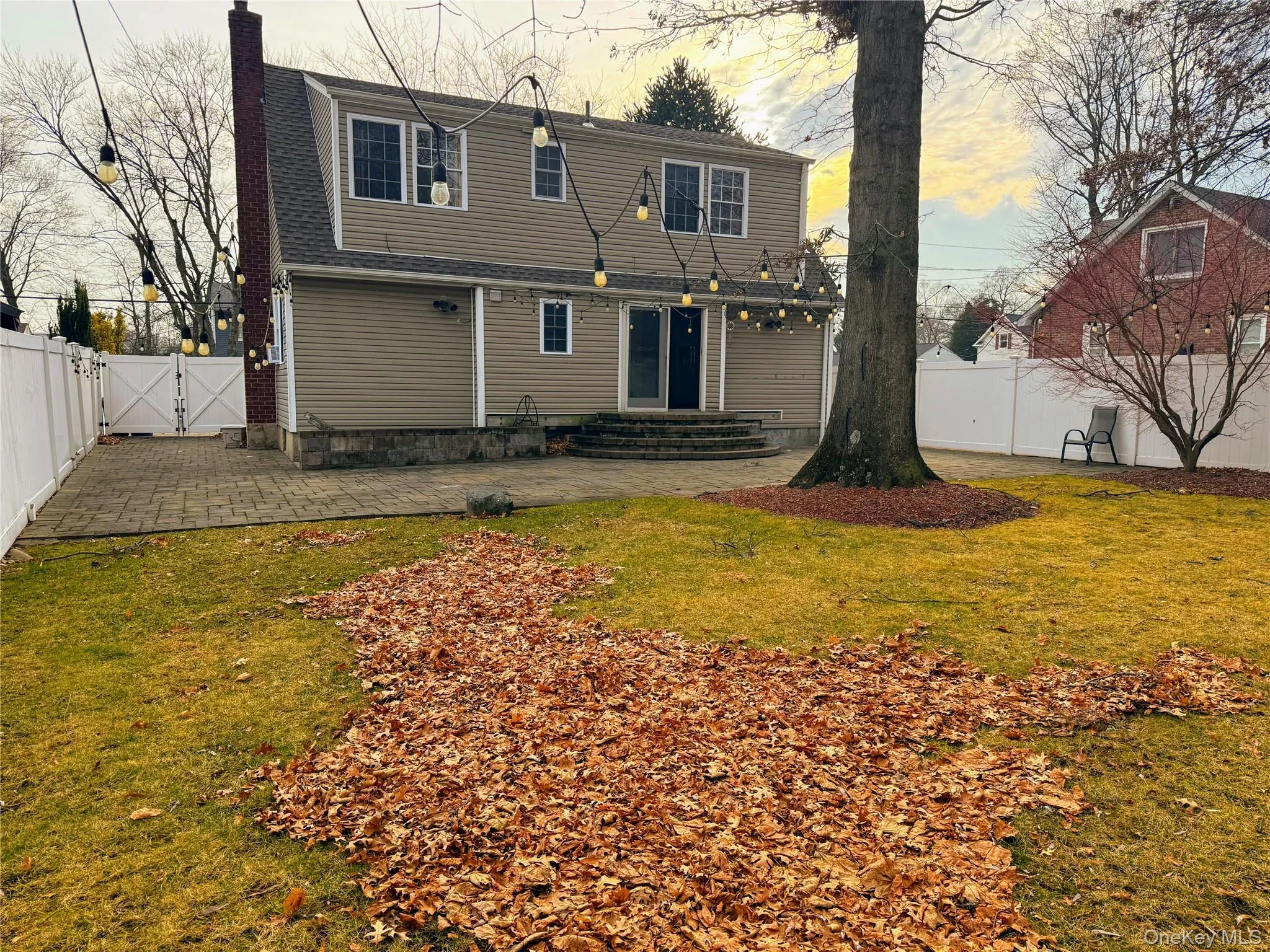 Back of house with a Dual PVC Gate, a patio area, a fenced backyard Back of house with a Dual PVC Gate, a patio area, a fenced backyard