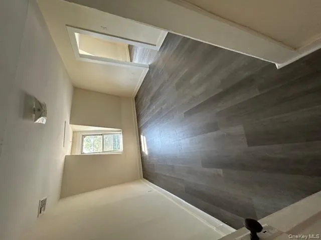 Additional living space featuring dark wood-type flooring and baseboards Additional living space featuring dark wood-type flooring and baseboards