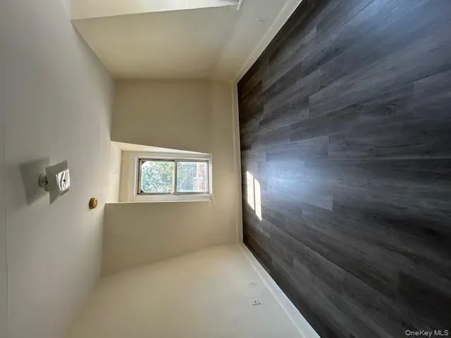 Additional living space with dark wood-type flooring and baseboards Additional living space with dark wood-type flooring and baseboards