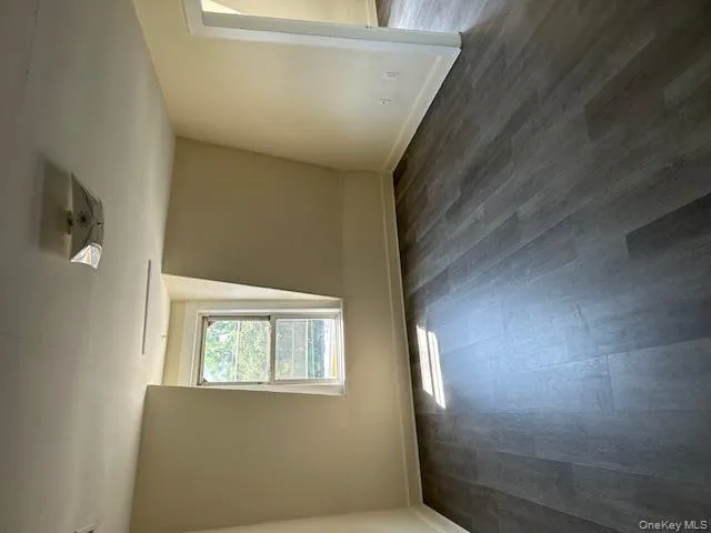 Additional living space featuring dark wood-style floors and baseboards Additional living space featuring dark wood-style floors and baseboards