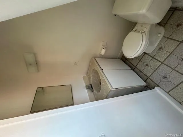 Half bathroom featuring vanity and light tile patterned flooring Half bathroom featuring vanity and light tile patterned flooring