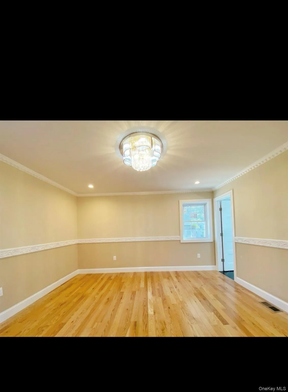 Unfurnished room with a chandelier, ornamental molding, light wood-type flooring, and recessed lighting Unfurnished room with a chandelier, ornamental molding, light wood-type flooring, and recessed lighting