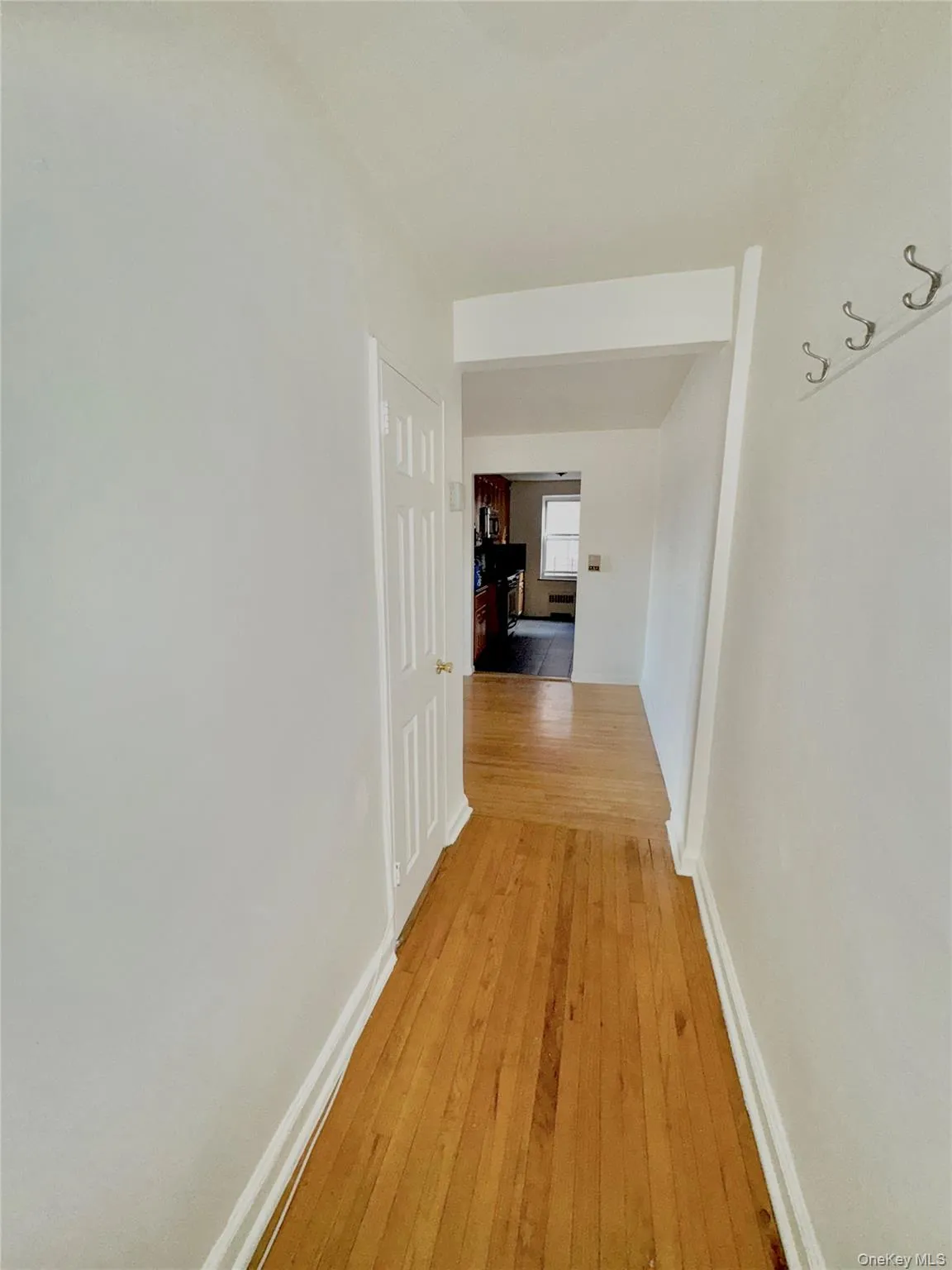 Corridor with light wood finished floors and baseboards Corridor with light wood finished floors and baseboards