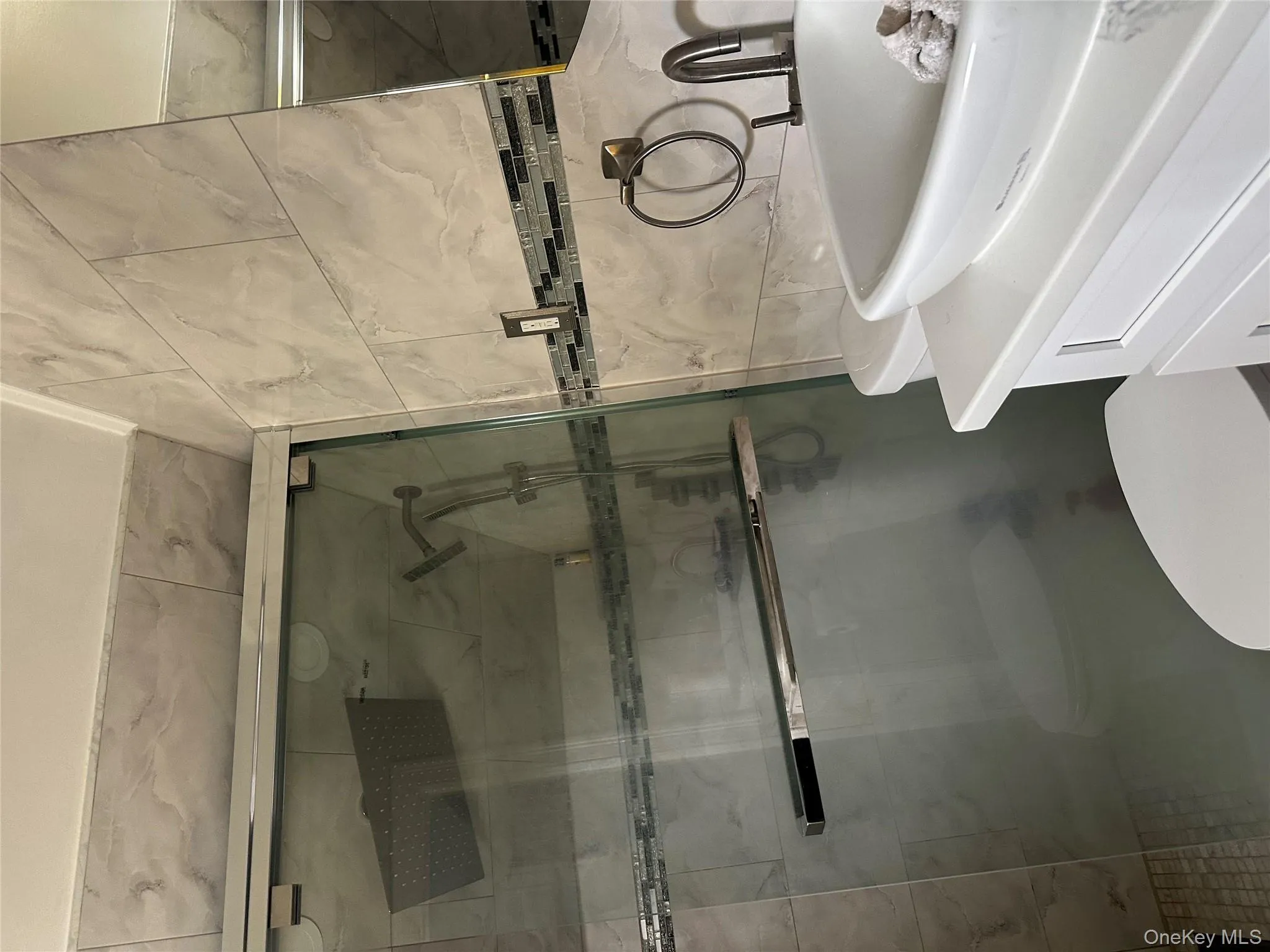 Bathroom featuring vanity, tile walls, and a shower stall Bathroom featuring vanity, tile walls, and a shower stall