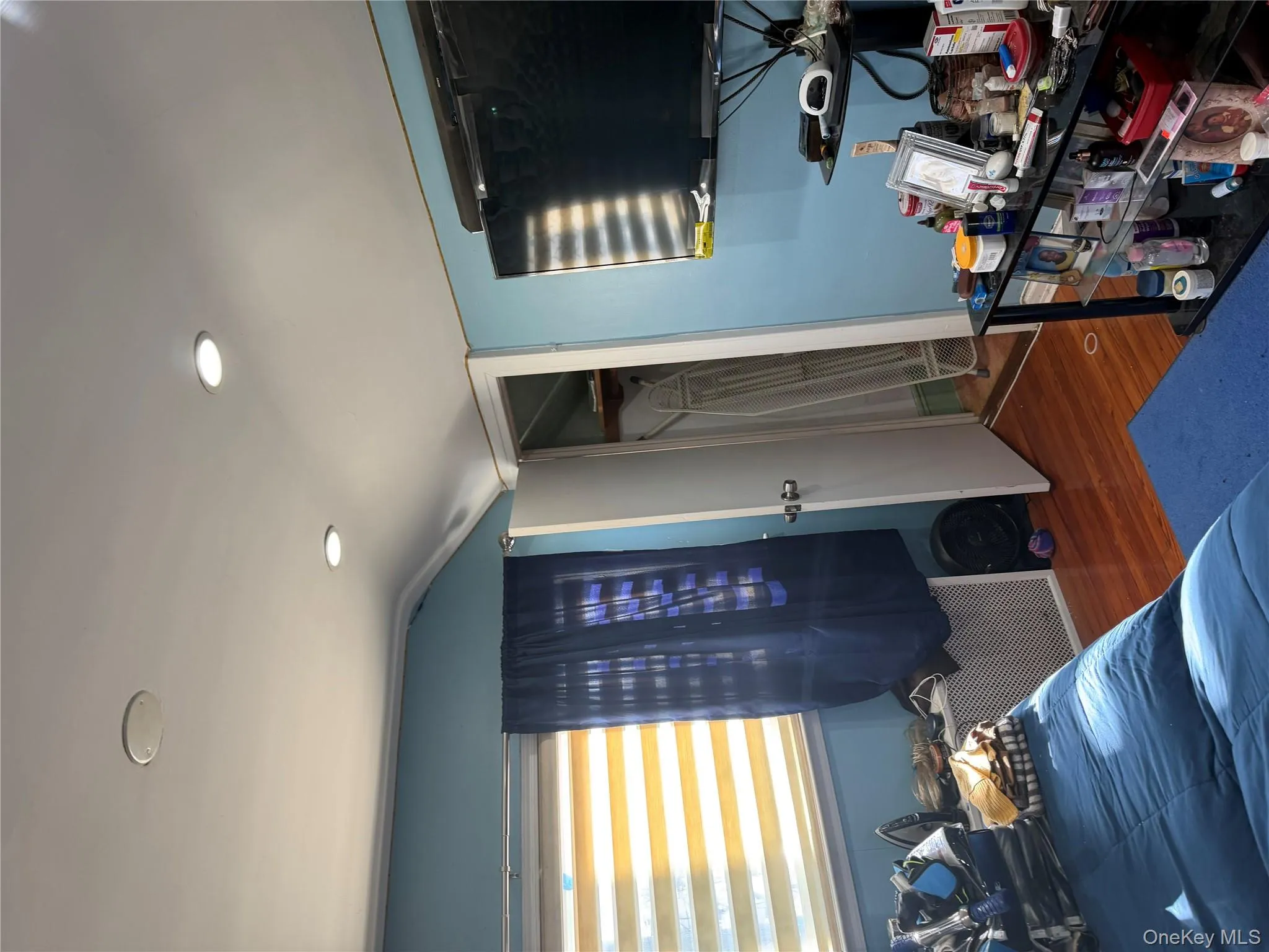 Bedroom with a closet, dark wood finished floors, lofted ceiling, and recessed lighting Bedroom with a closet, dark wood finished floors, lofted ceiling, and recessed lighting