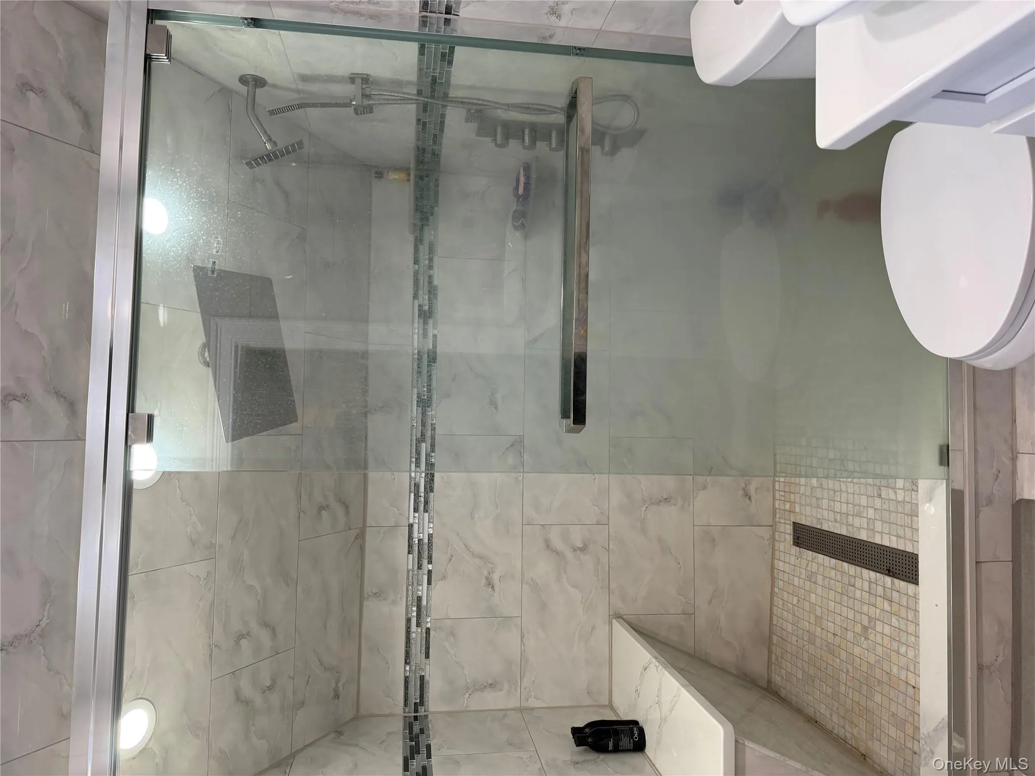 Bathroom with vanity and a shower stall Bathroom with vanity and a shower stall