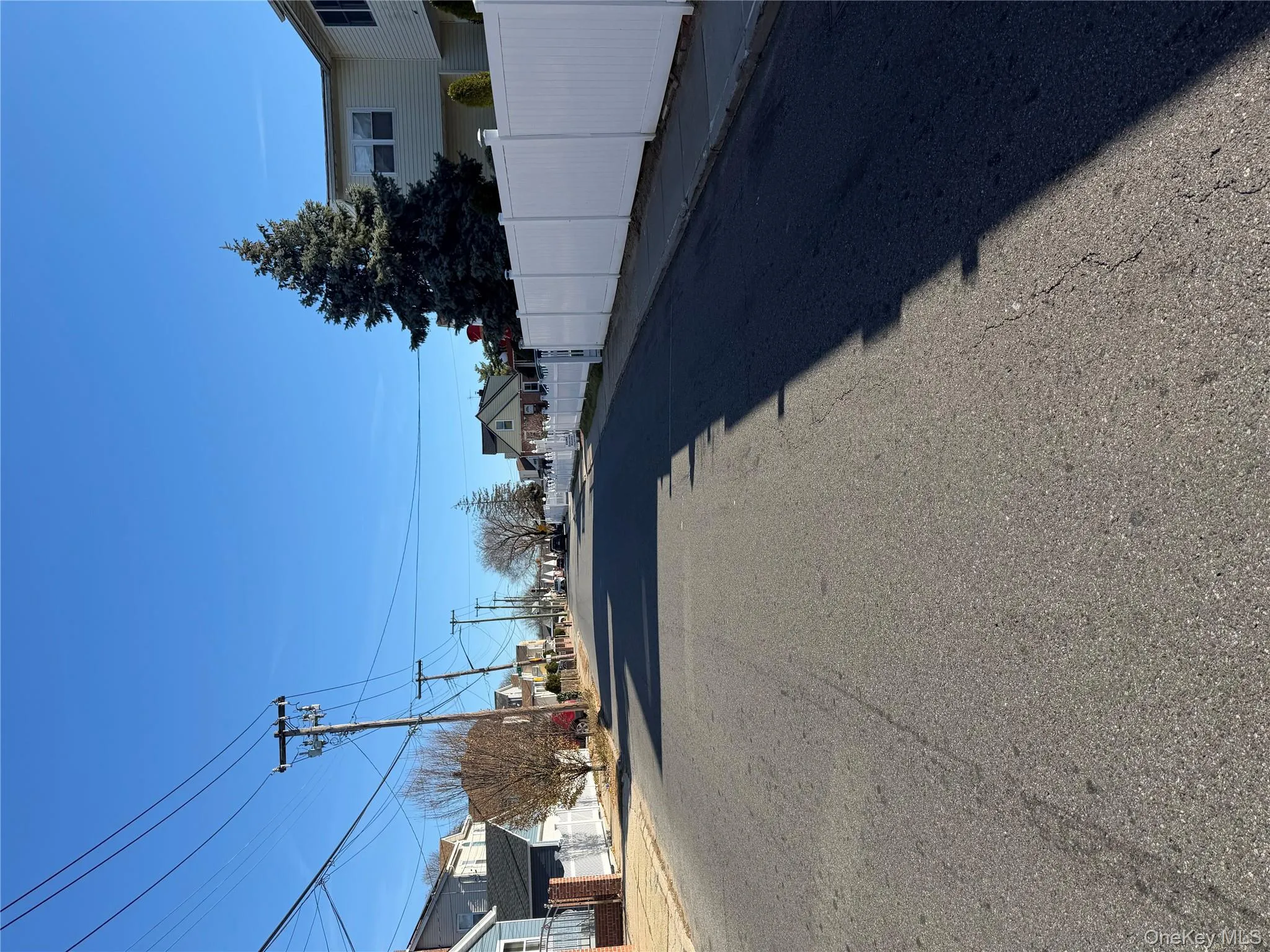 View of asphalt road with curbs and sidewalks View of asphalt road with curbs and sidewalks
