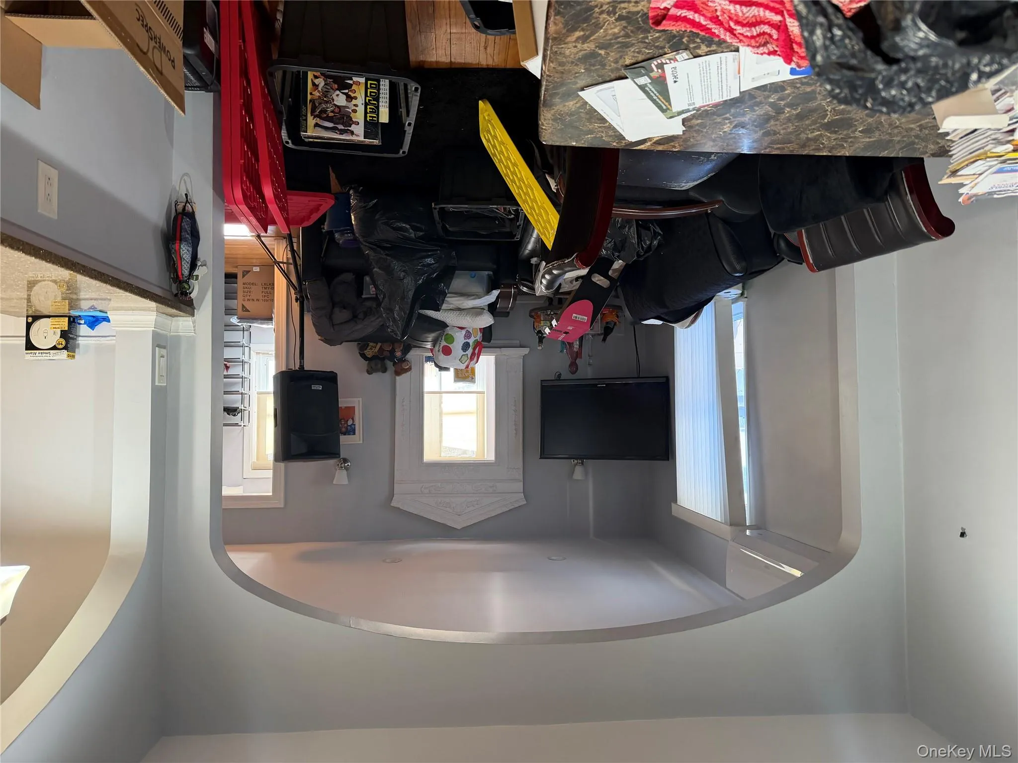 Living room featuring arched walkways and wood finished floors Living room featuring arched walkways and wood finished floors