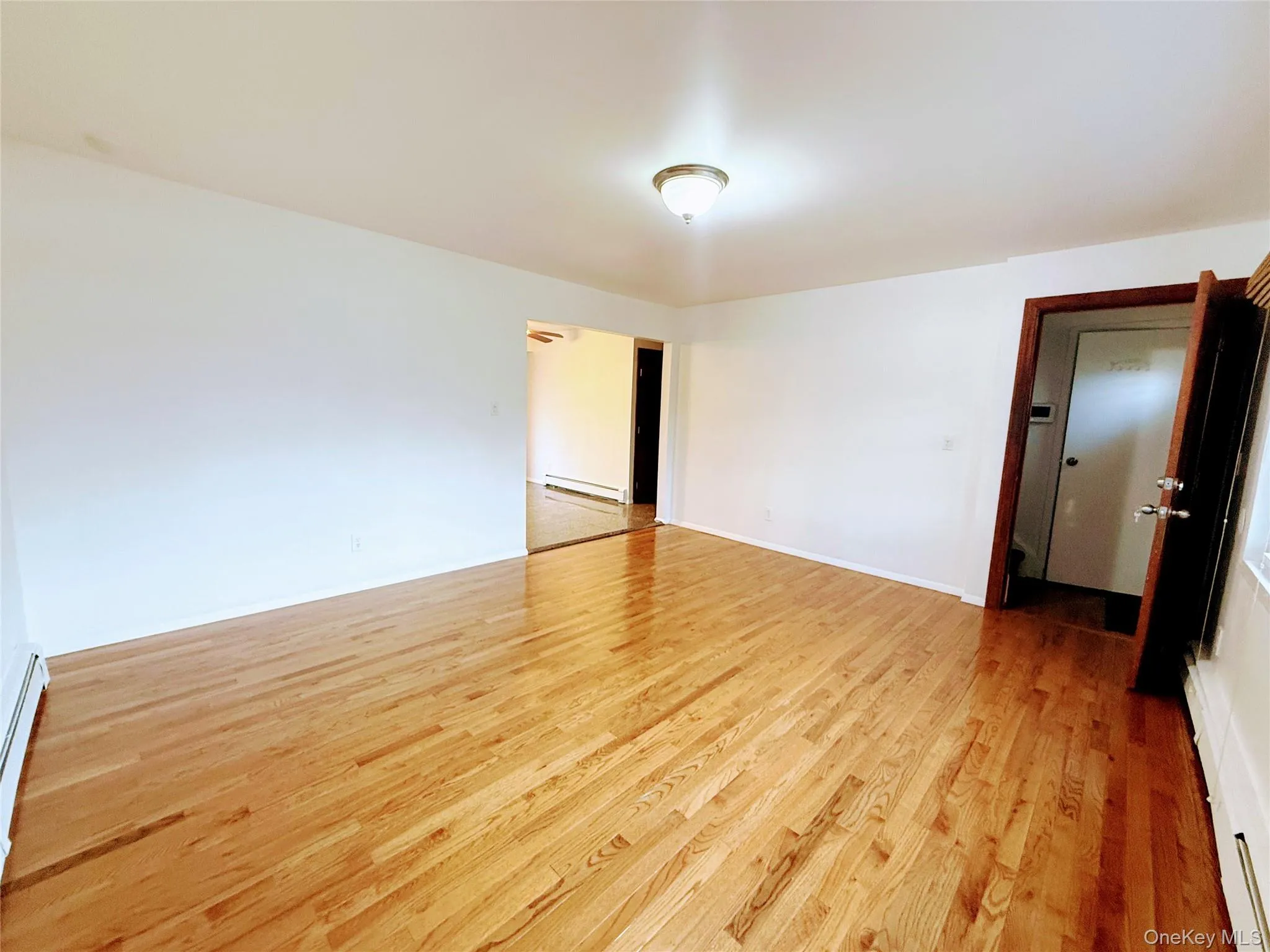 Entry into Living Room featuring hard wood floors Entry into Living Room featuring hard wood floors