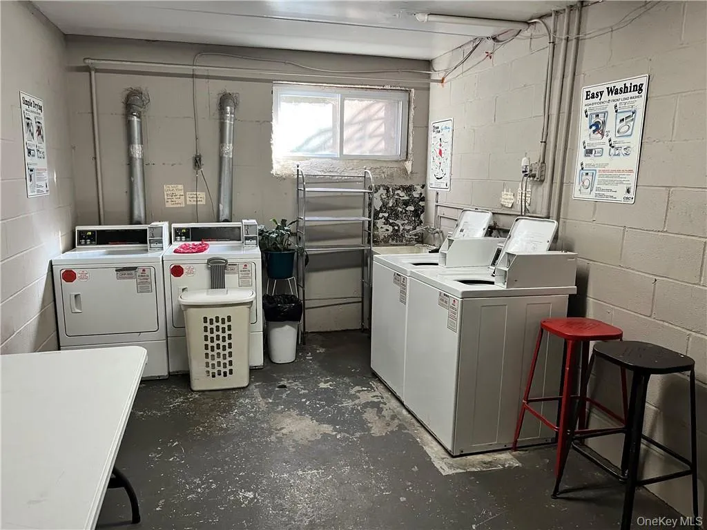Shared laundry room with separate washer and dryer Shared laundry room with separate washer and dryer