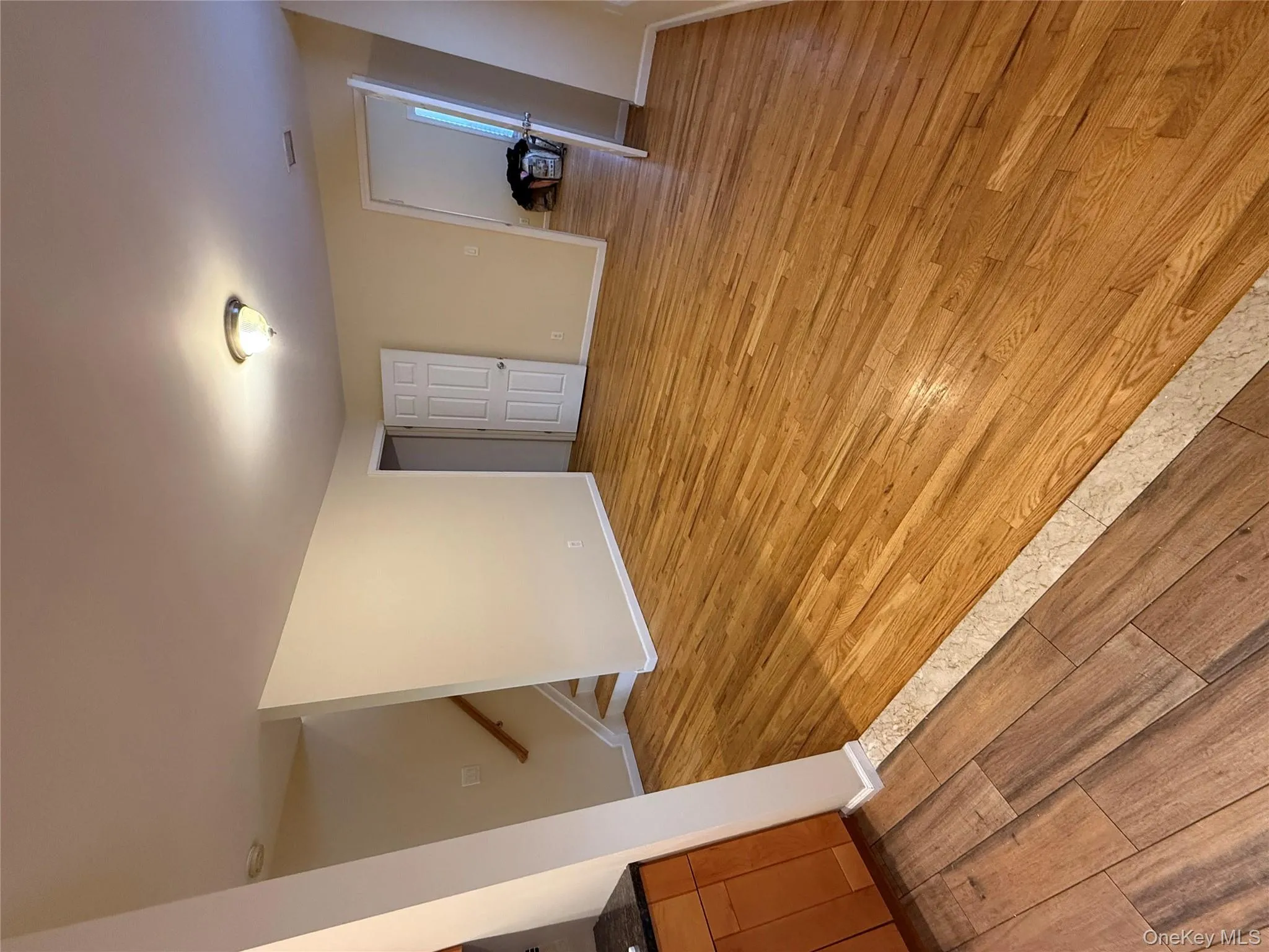 Unfurnished living room featuring light wood-type flooring and stairs Unfurnished living room featuring light wood-type flooring and stairs