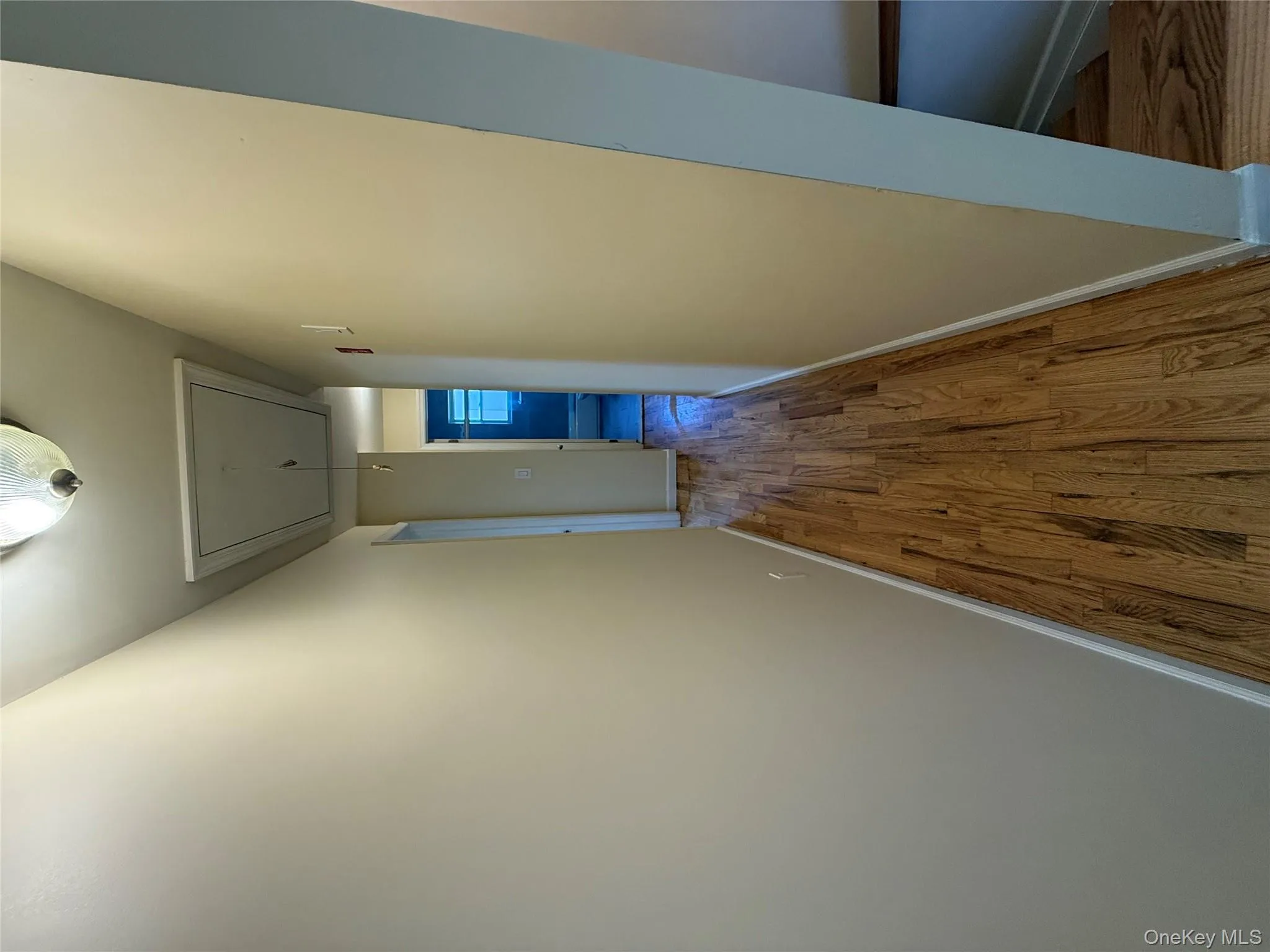 Corridor with attic access and wood finished floors Corridor with attic access and wood finished floors