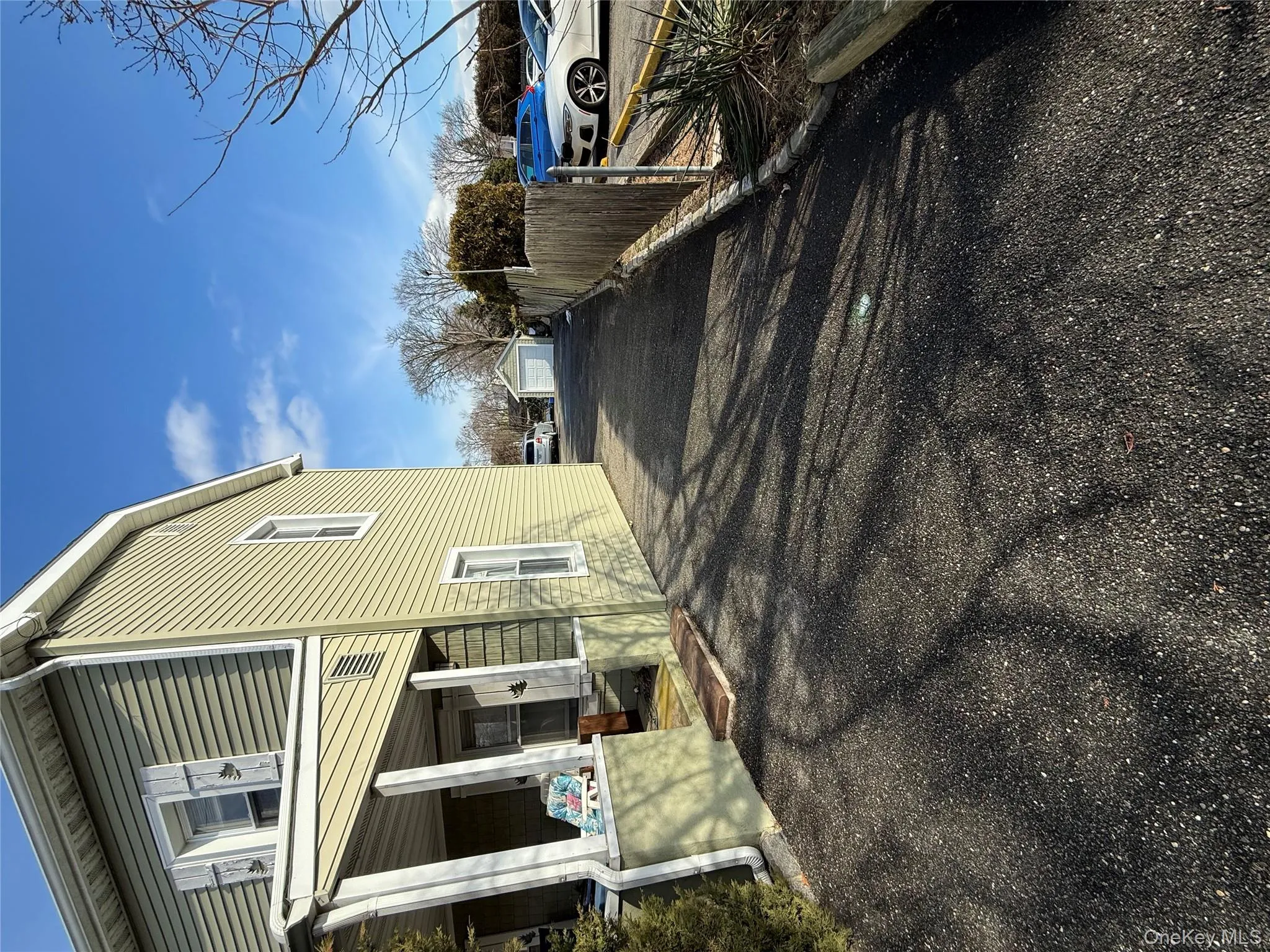 View of home's exterior with a garage, an outbuilding, covered porch, and driveway View of home's exterior with a garage, an outbuilding, covered porch, and driveway