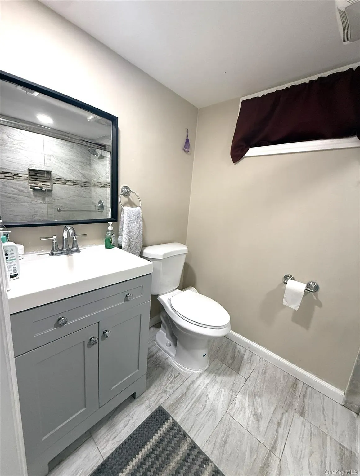 Full bathroom featuring vanity and a shower Full bathroom featuring vanity and a shower