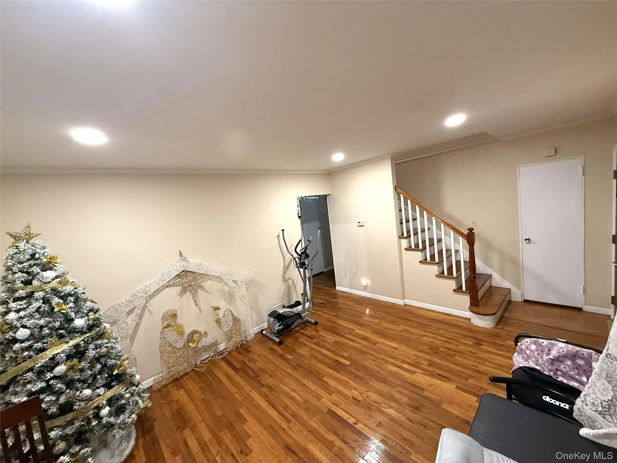 Workout area with wood finished floors, crown molding, and recessed lighting Workout area with wood finished floors, crown molding, and recessed lighting