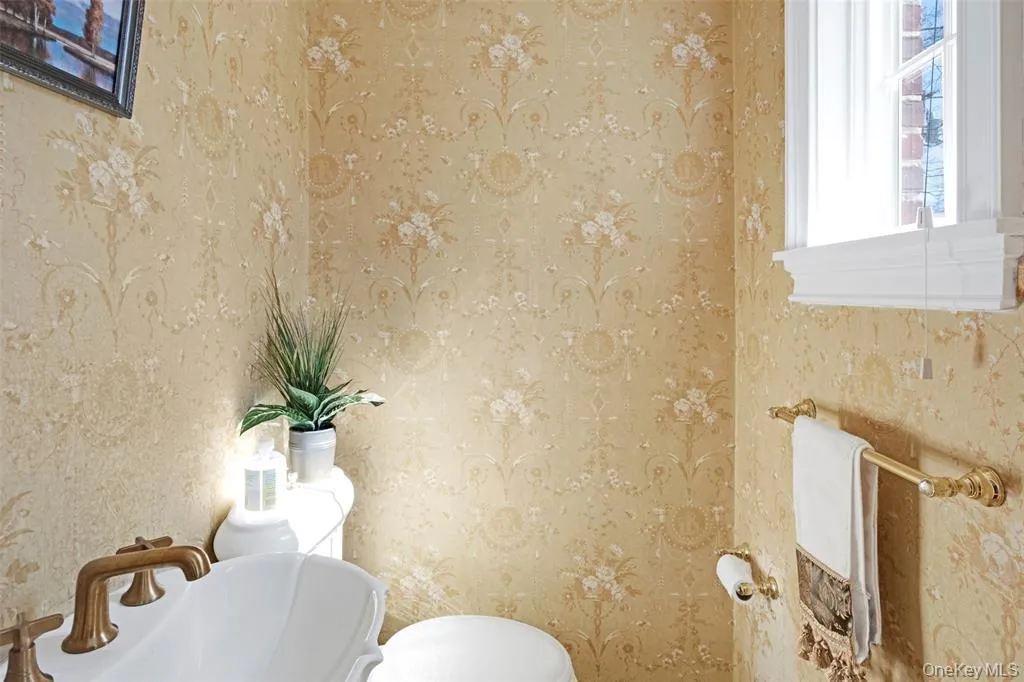 Bathroom with wallpapered walls Bathroom with wallpapered walls