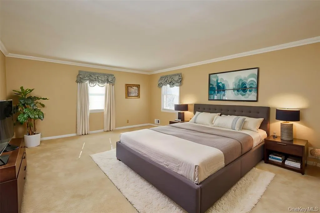 Bedroom with carpet and ornamental molding Bedroom with carpet and ornamental molding