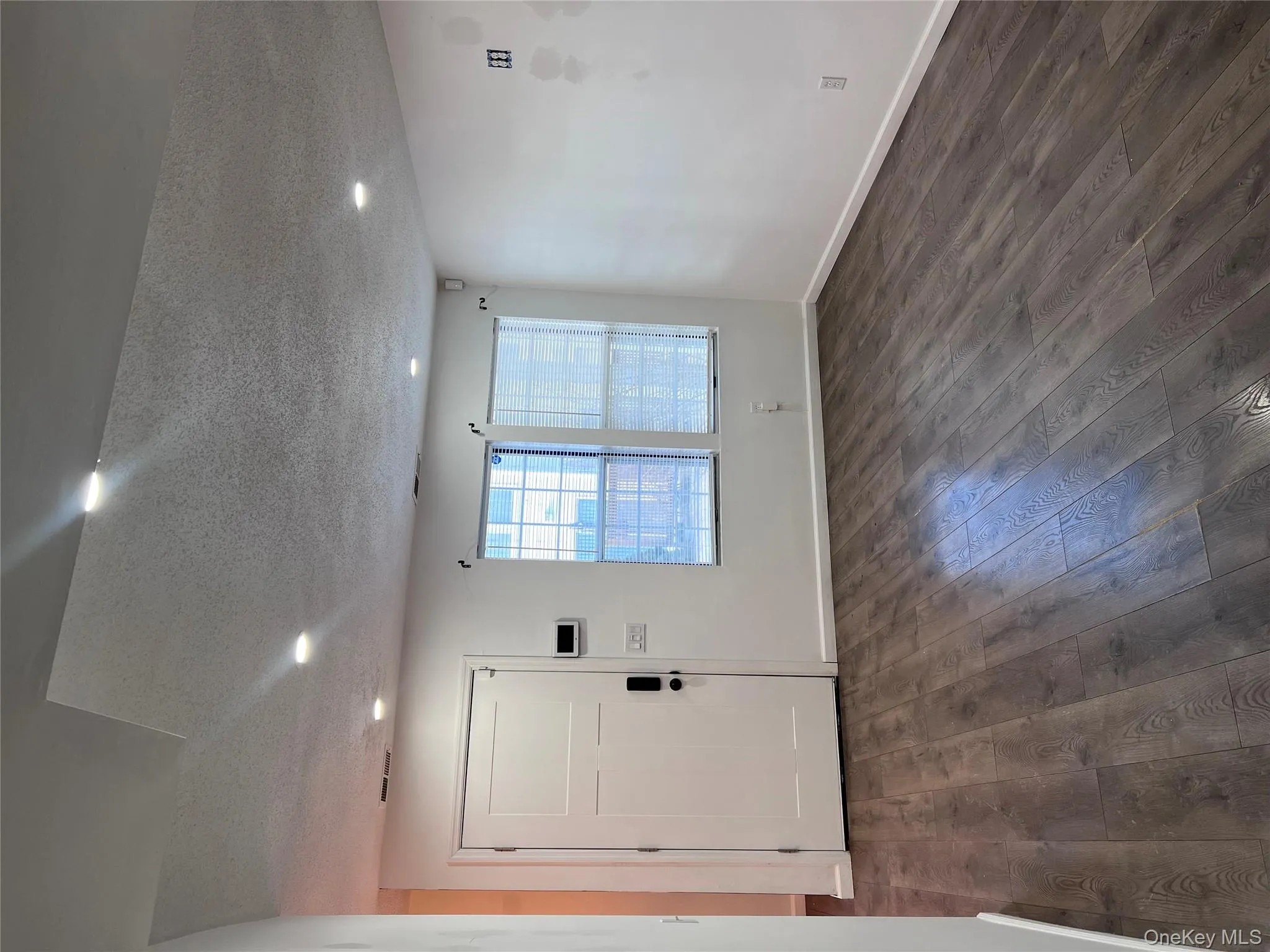 Foyer featuring dark hardwood / wood-style flooring and a textured ceiling Foyer featuring dark hardwood / wood-style flooring and a textured ceiling