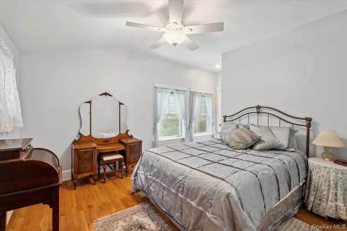 Bedroom with light wood-style flooring, vaulted ceiling, and ceiling fan Bedroom with light wood-style flooring, vaulted ceiling, and ceiling fan