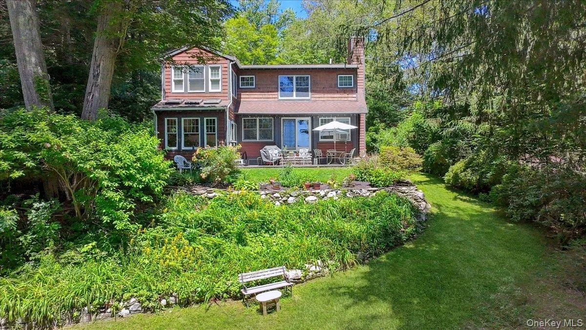 View of front of property featuring a chimney and a front yard View of front of property featuring a chimney and a front yard