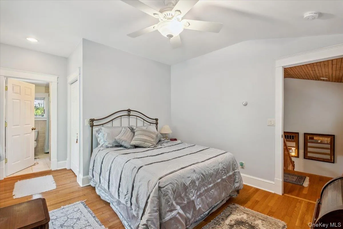 Bedroom featuring light wood finished floors, vaulted ceiling, ceiling fan, and recessed lighting Bedroom featuring light wood finished floors, vaulted ceiling, ceiling fan, and recessed lighting