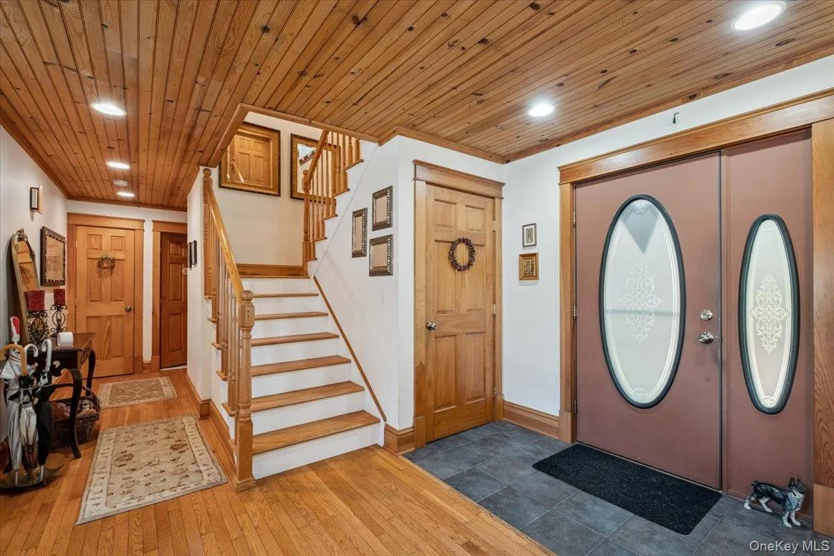 Foyer entrance featuring recessed lighting, stairway, wood ceiling, and wood-type flooring Foyer entrance featuring recessed lighting, stairway, wood ceiling, and wood-type flooring