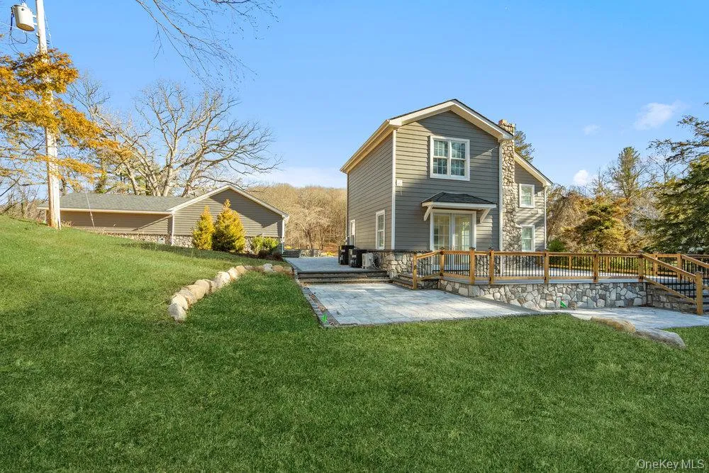 Rear view of house with a yard, a patio, and a wooden deck Rear view of house with a yard, a patio, and a wooden deck
