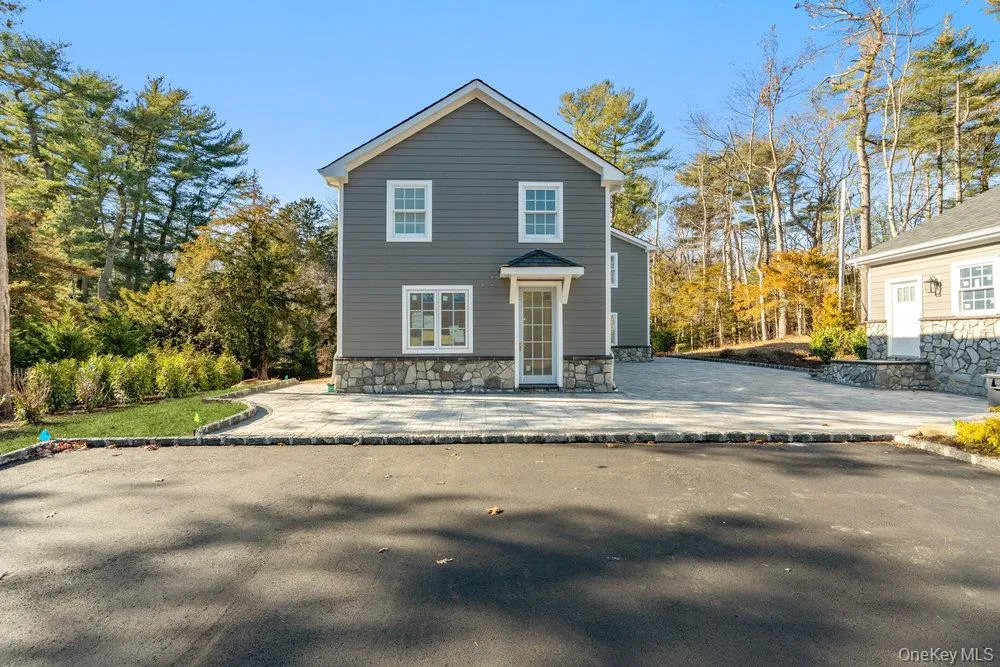 Rear view of property featuring a patio and stone siding Rear view of property featuring a patio and stone siding