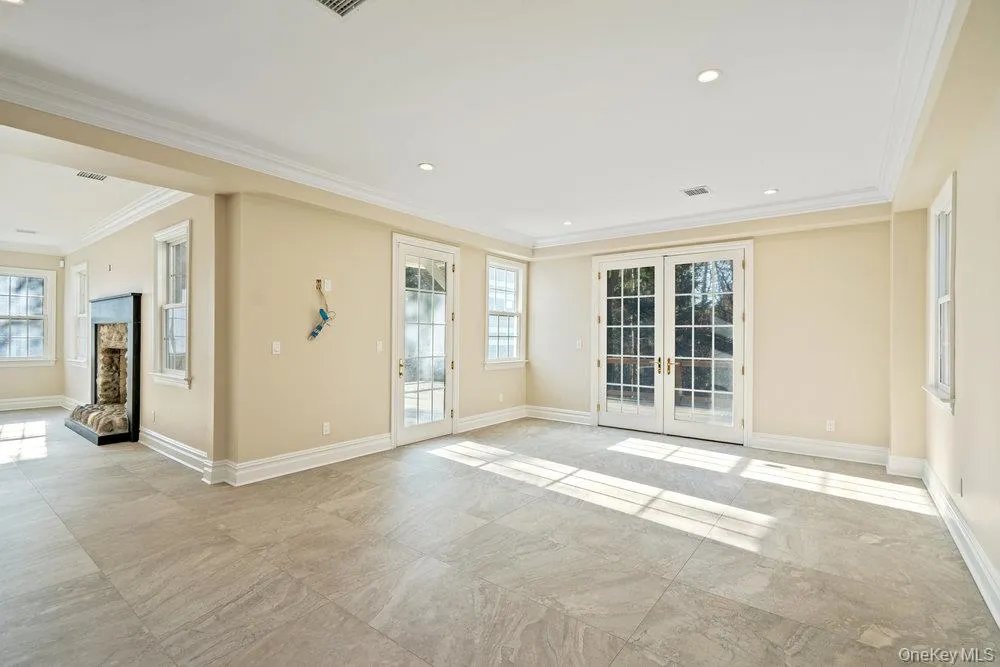 Unfurnished room featuring french doors, recessed lighting, and crown molding Unfurnished room featuring french doors, recessed lighting, and crown molding