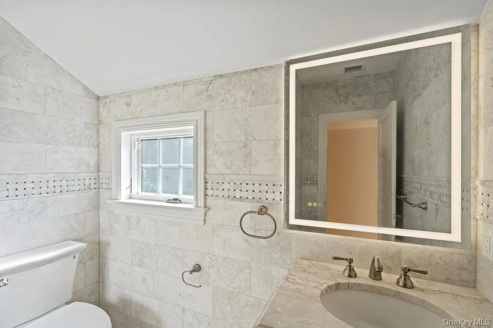Bathroom with vanity and tile walls Bathroom with vanity and tile walls