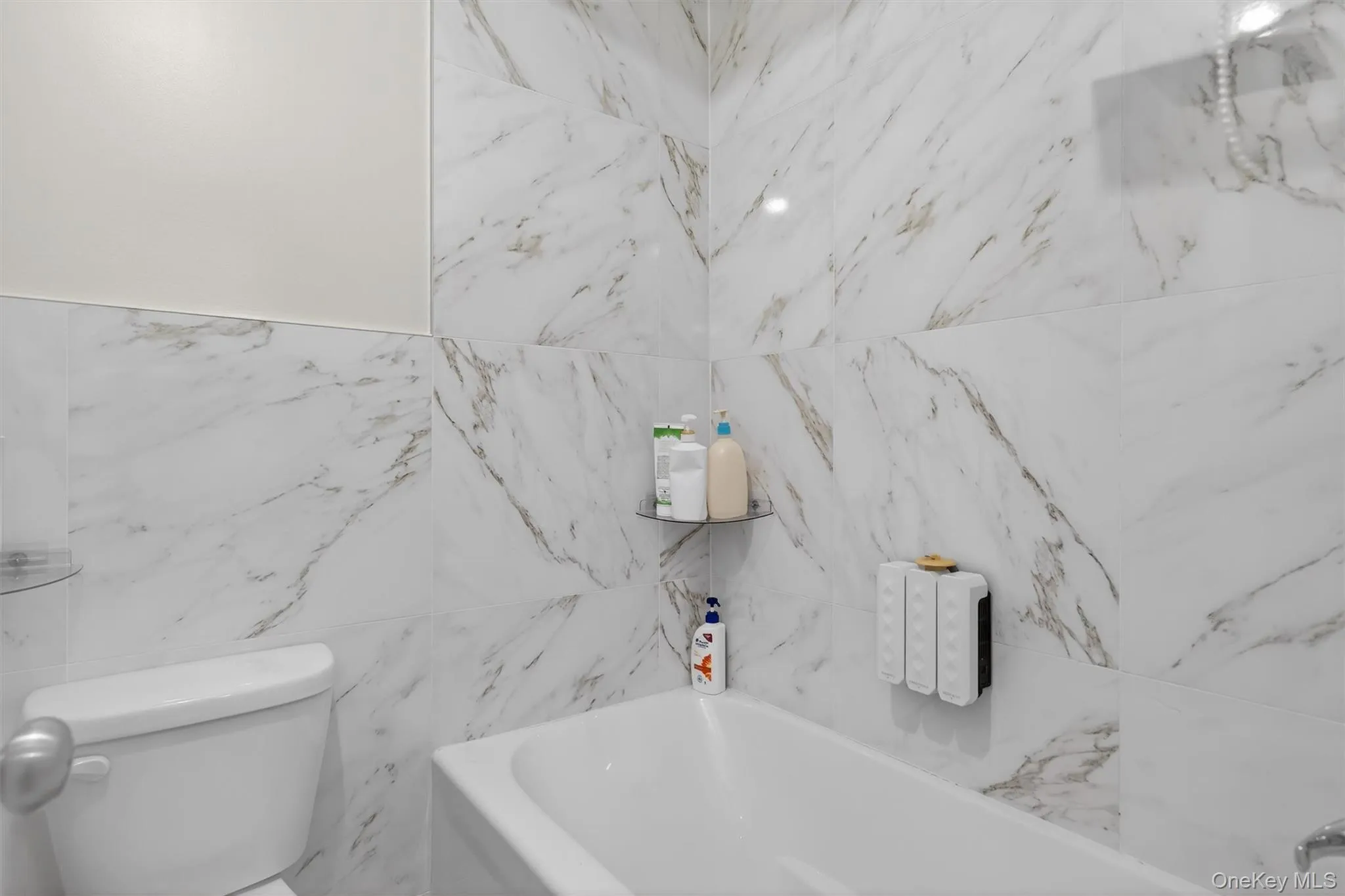 Bathroom with a tub and tile walls Bathroom with a tub and tile walls