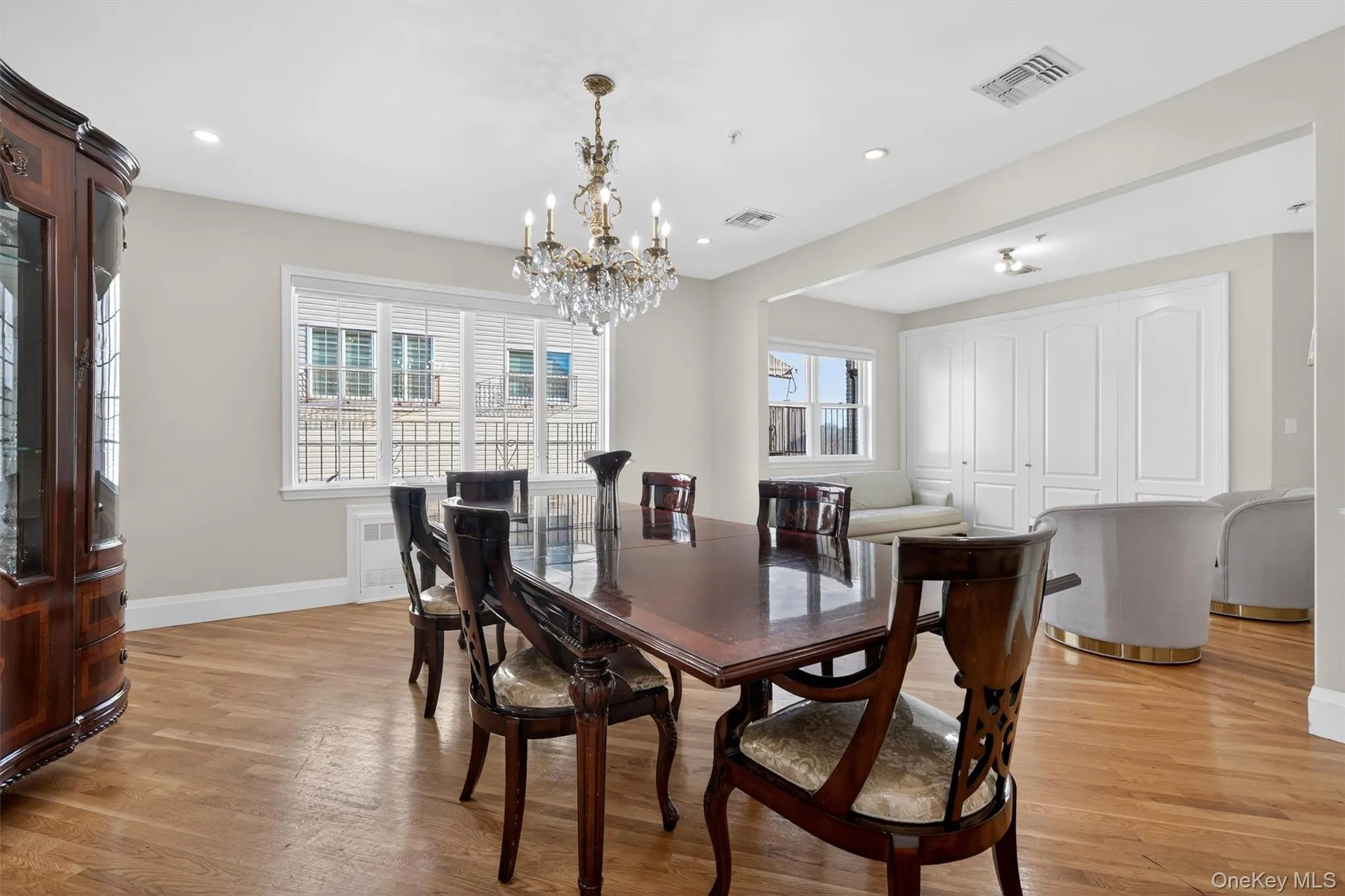 Dining space with light wood-type flooring, plenty of natural light, recessed lighting, radiator heating unit, and a chandelier Dining space with light wood-type flooring, plenty of natural light, recessed lighting, radiator heating unit, and a chandelier