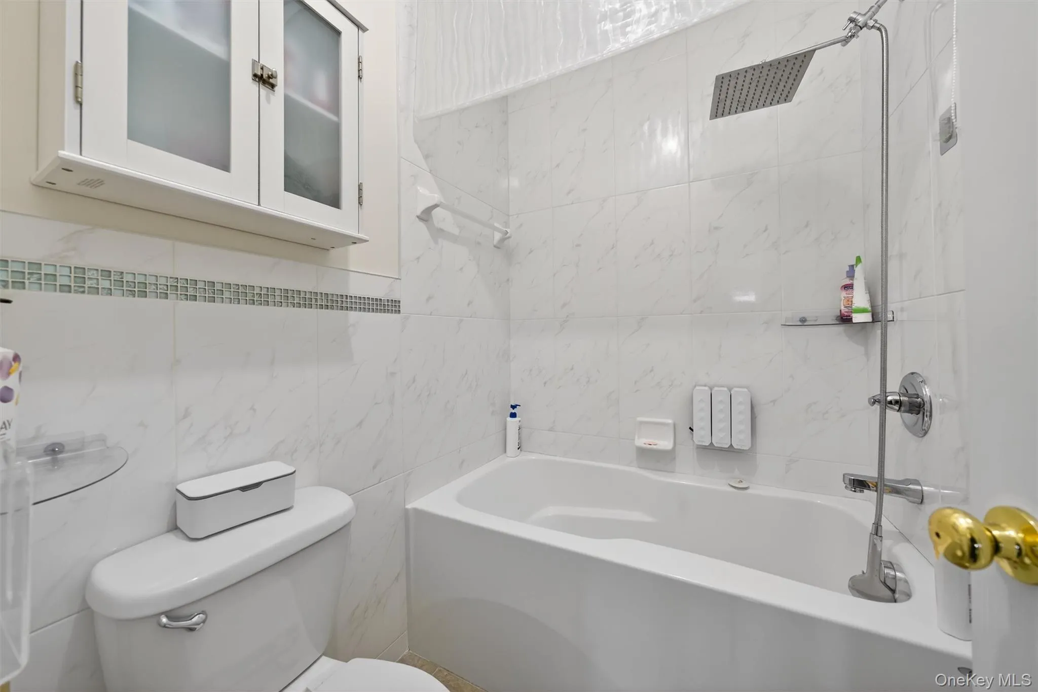 Master bedroom's Full bathroom features a tub/shower combination and tile walls Master bedroom's Full bathroom features a tub/shower combination and tile walls