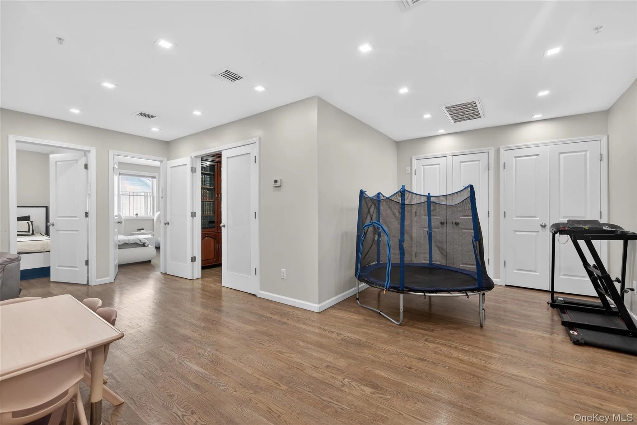 Playroom area with wood finished floors and recessed lighting Playroom area with wood finished floors and recessed lighting