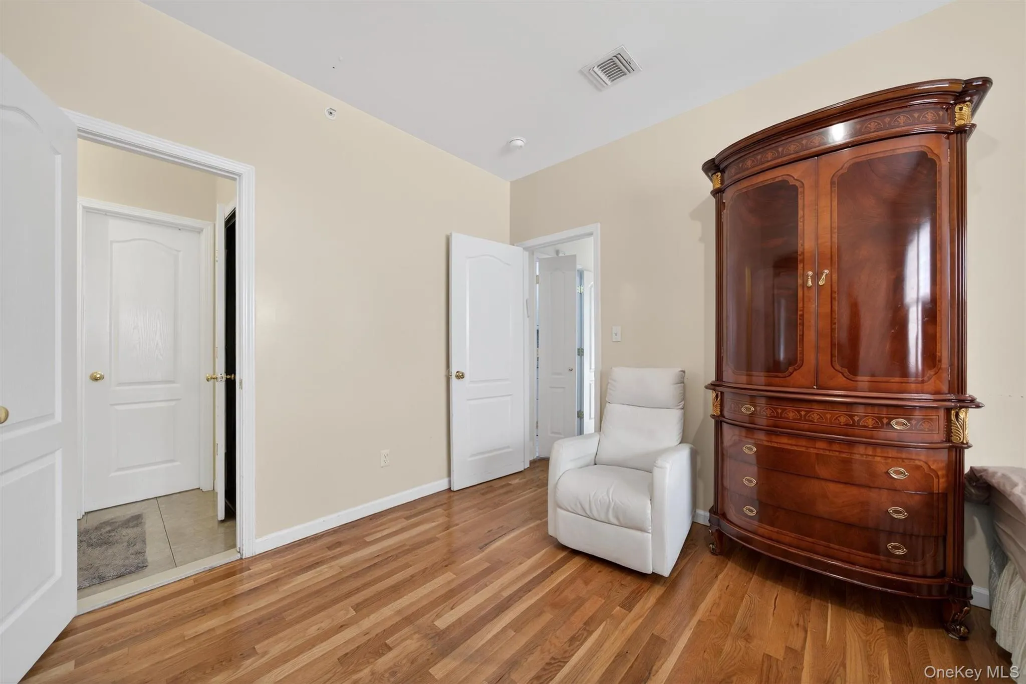 Sitting room featuring light wood-type flooring and baseboards Sitting room featuring light wood-type flooring and baseboards
