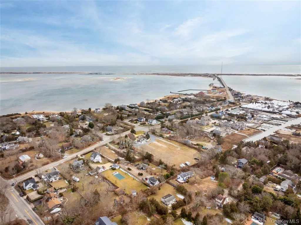 Aerial overview of property's location featuring a large body of water and nearby suburban area Aerial overview of property's location featuring a large body of water and nearby suburban area