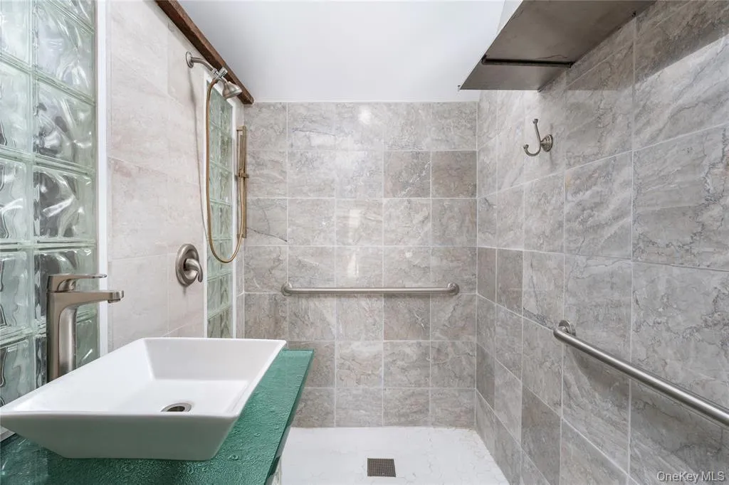 Full bath with tiled shower and vanity Full bath with tiled shower and vanity