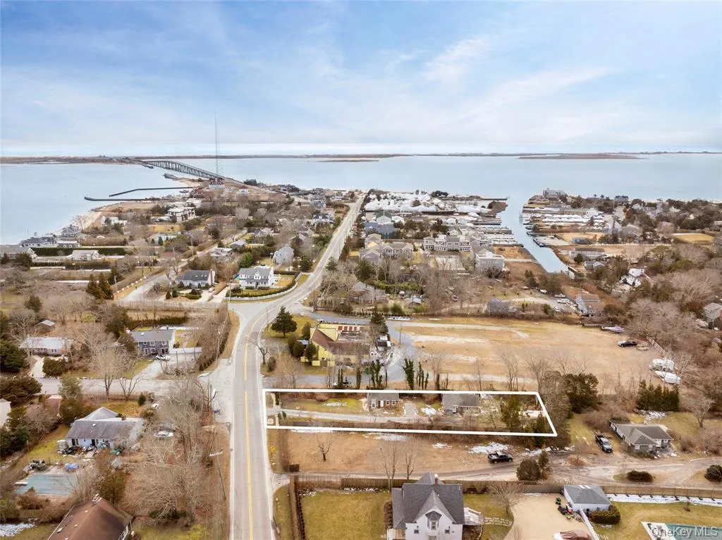 Aerial overview of property's location featuring a notable bridge, a large body of water, and property parcel outlined Aerial overview of property's location featuring a notable bridge, a large body of water, and property parcel outlined