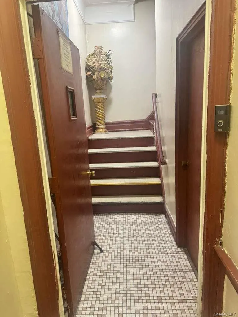 Corridor featuring stairway and light tile patterned floors Corridor featuring stairway and light tile patterned floors