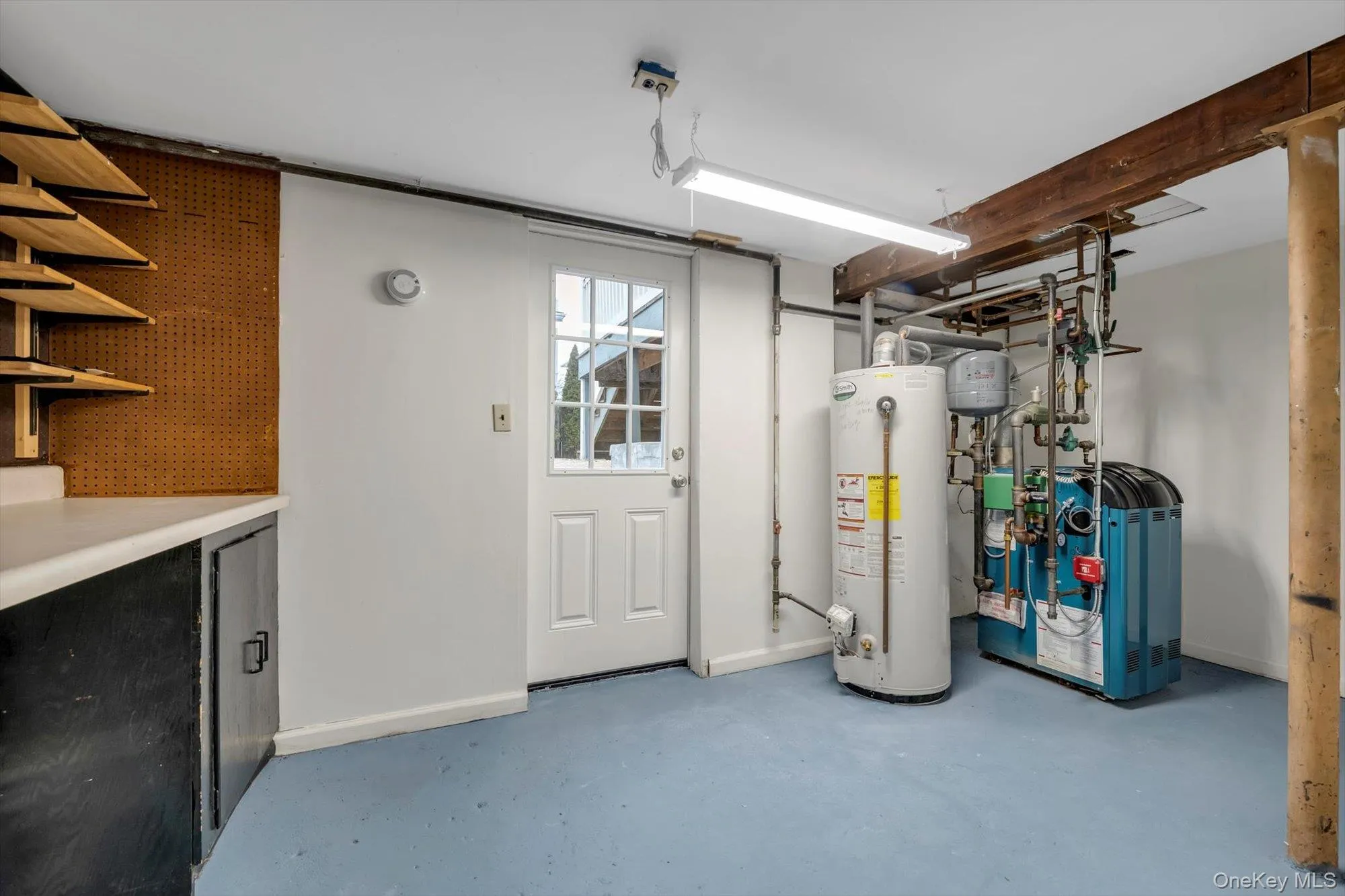 Below grade area with water heater and a heating unit Below grade area with water heater and a heating unit