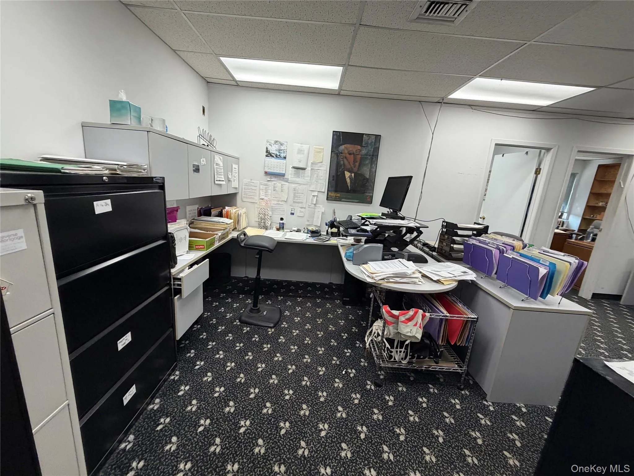 Office space with a paneled ceiling Office space with a paneled ceiling