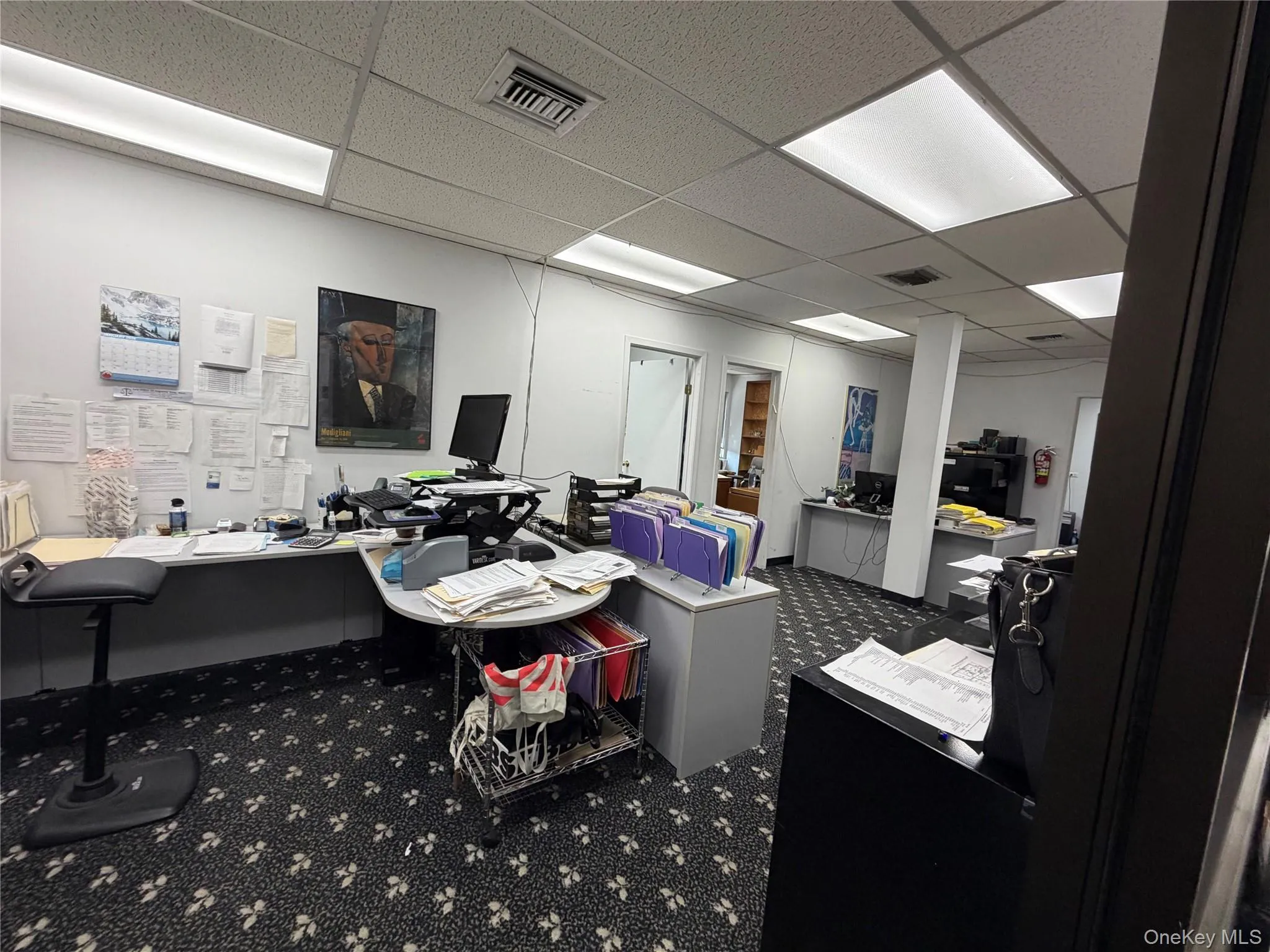 Home office with a paneled ceiling Home office with a paneled ceiling