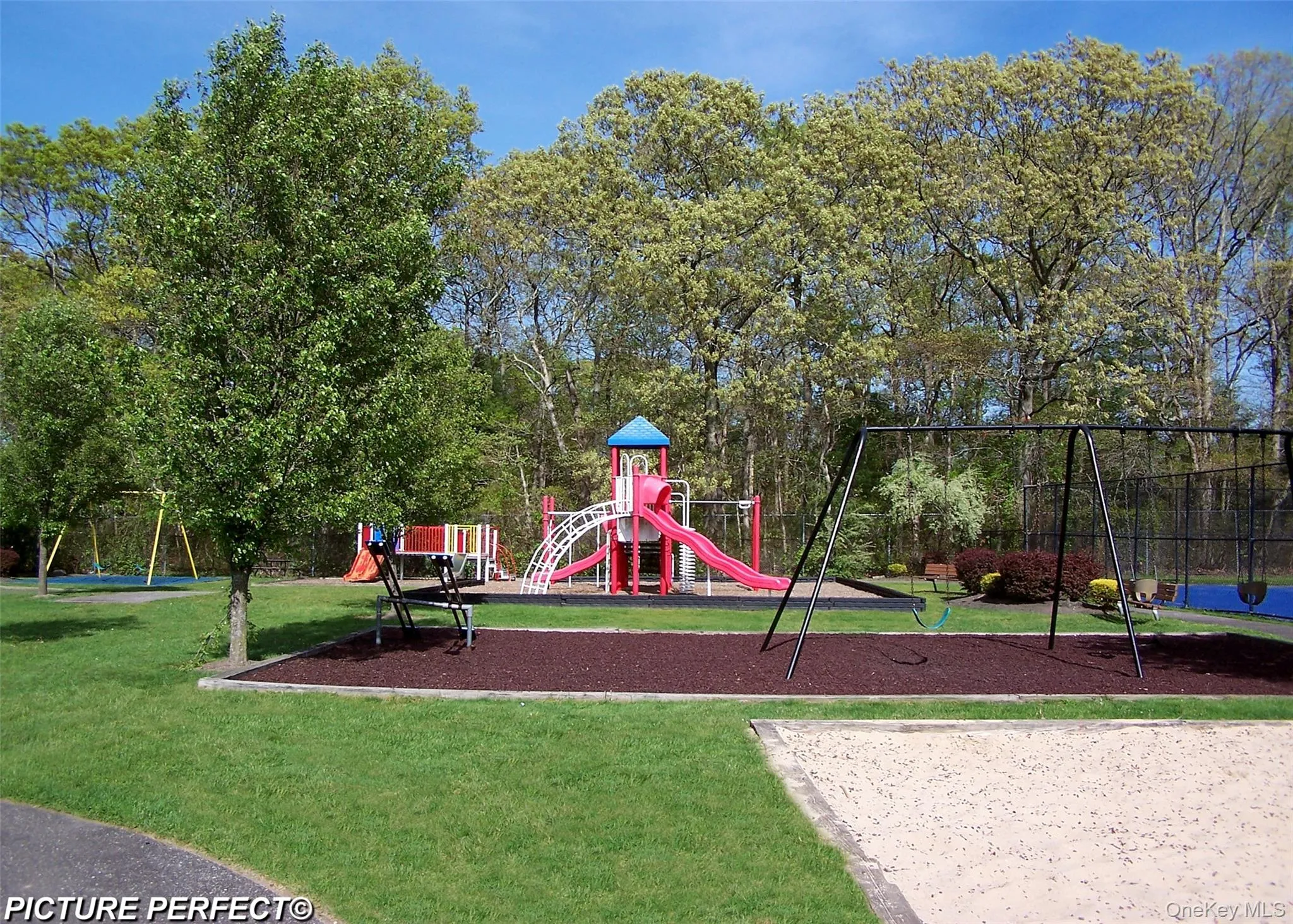 Community playground featuring a lawn Community playground featuring a lawn