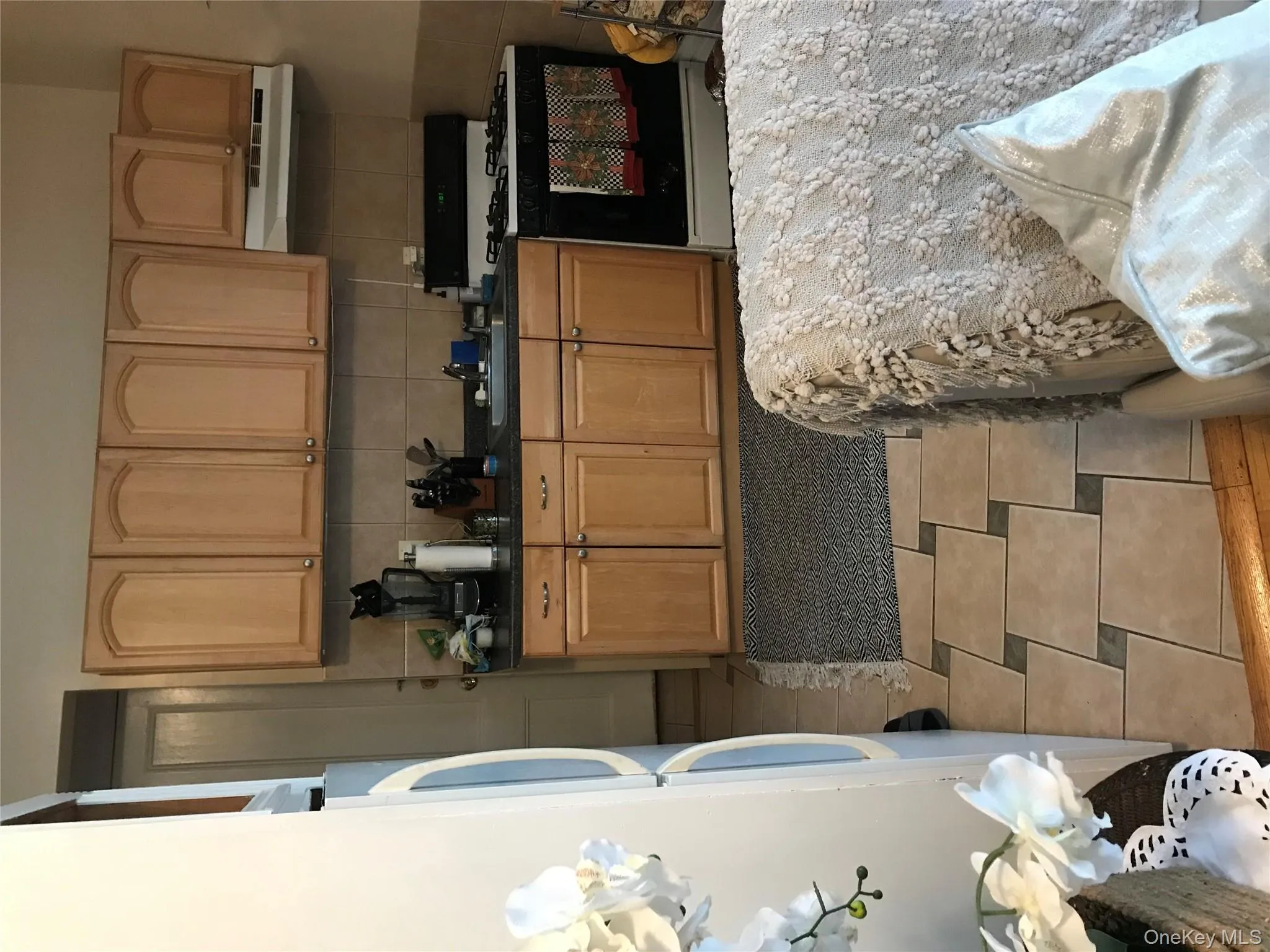 Kitchen with stove, range hood, refrigerator, tasteful backsplash, and dark stone countertops Kitchen with stove, range hood, refrigerator, tasteful backsplash, and dark stone countertops