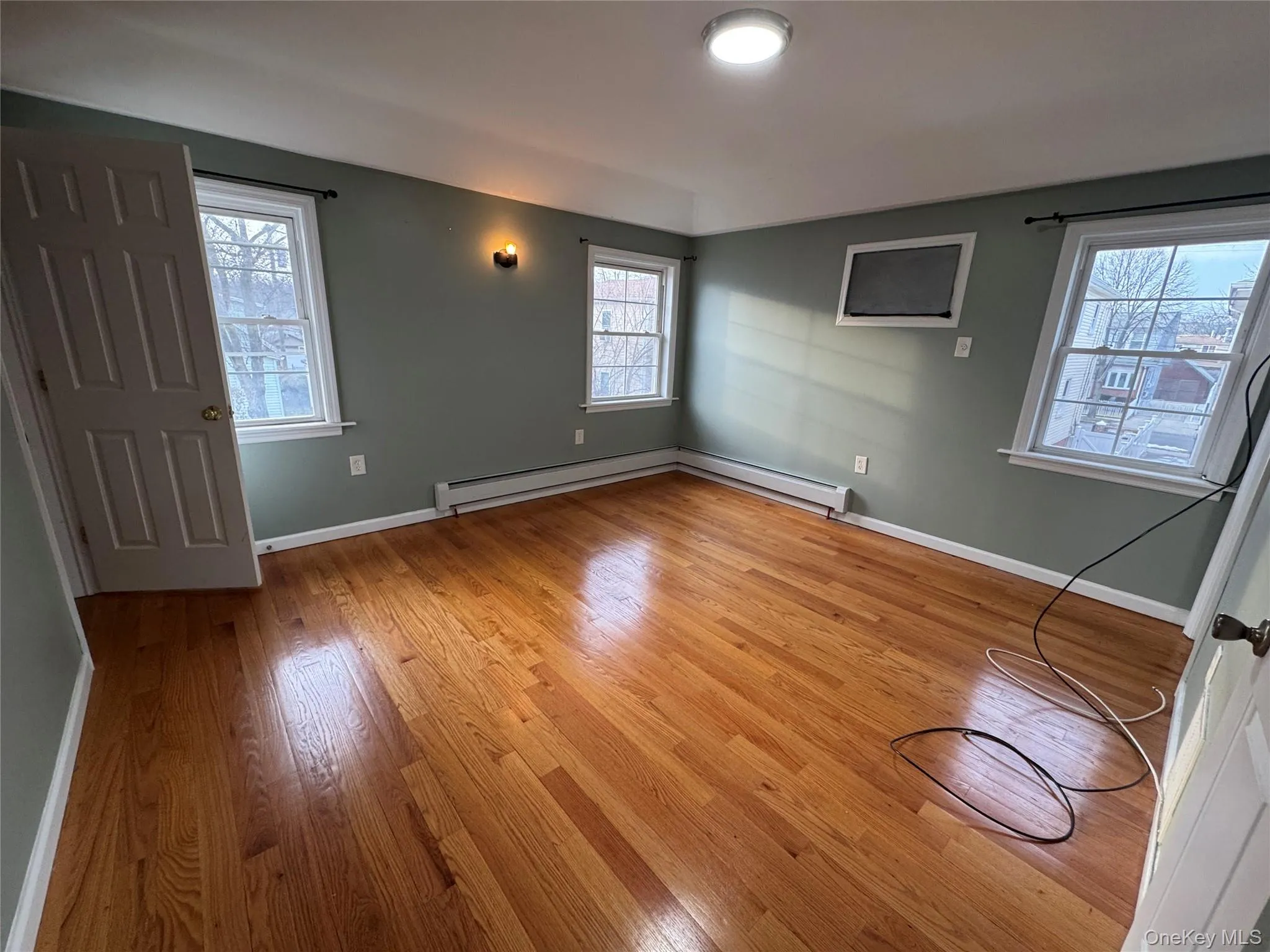 Spare room featuring light wood finished floors and baseboards Spare room featuring light wood finished floors and baseboards