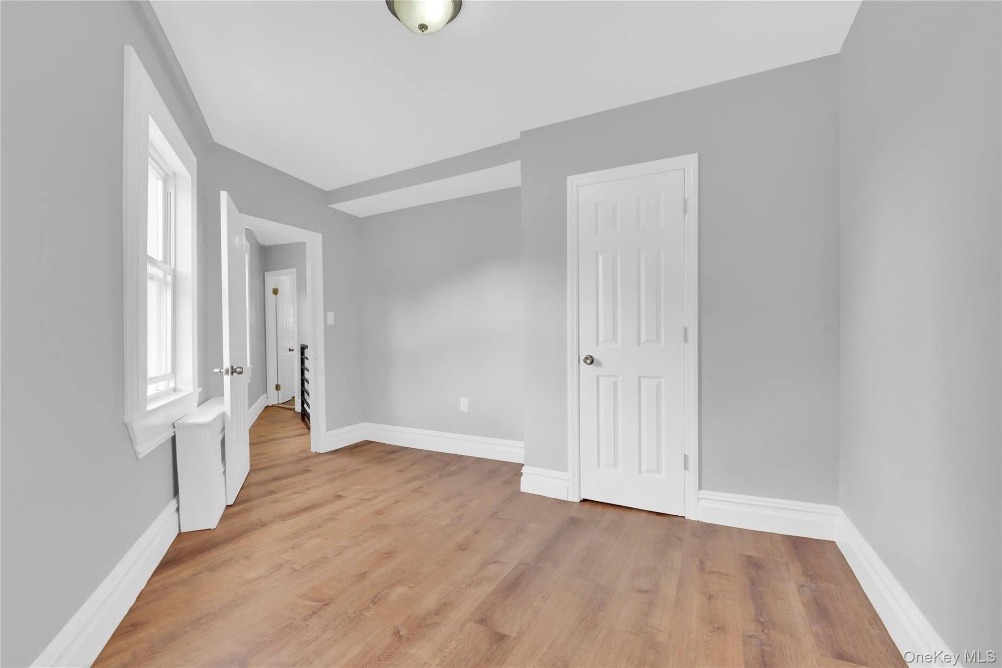 Unfurnished bedroom featuring light wood-type flooring and baseboards Unfurnished bedroom featuring light wood-type flooring and baseboards