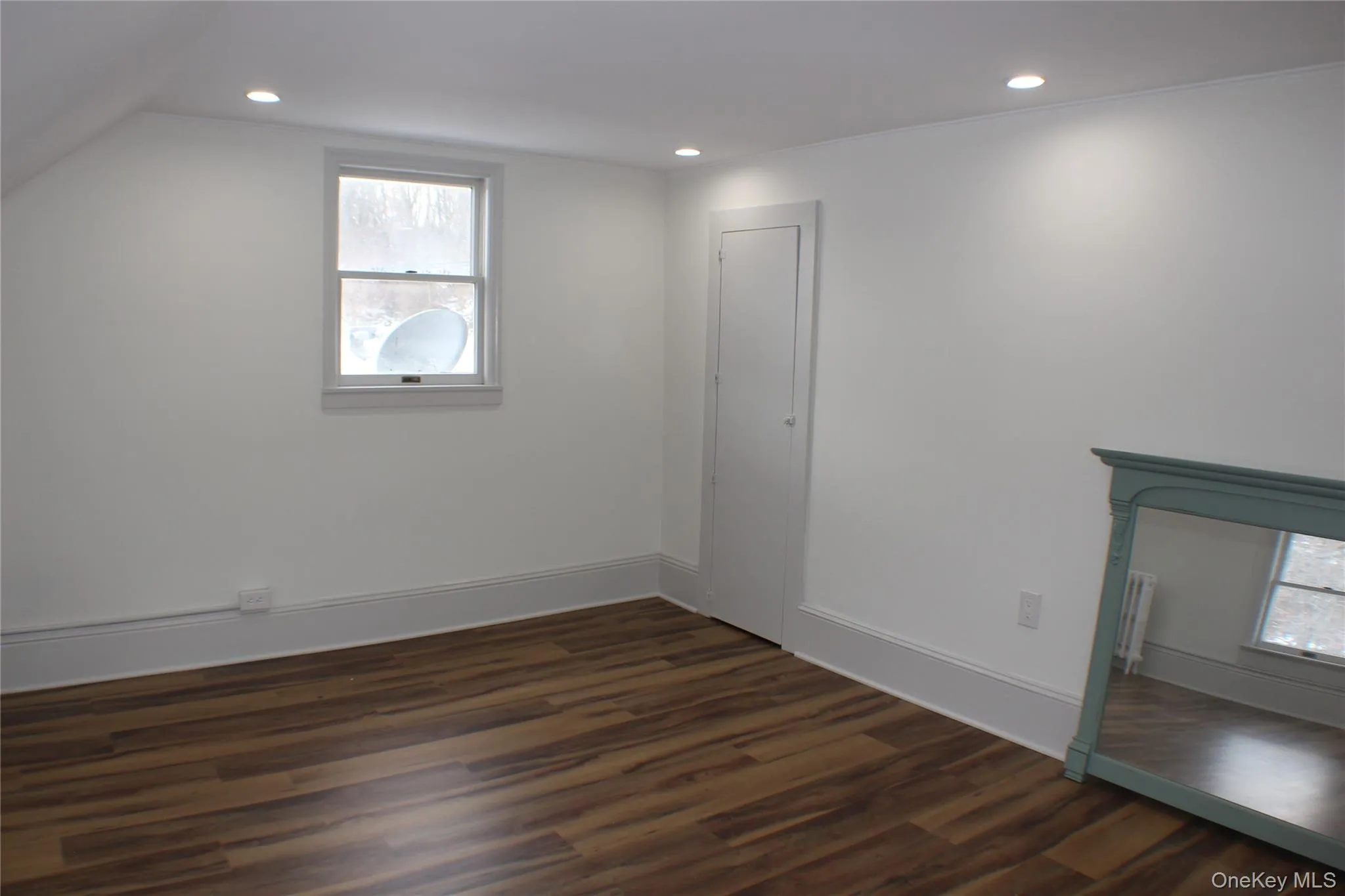 Bonus room with dark wood finished floors and recessed lighting Bonus room with dark wood finished floors and recessed lighting