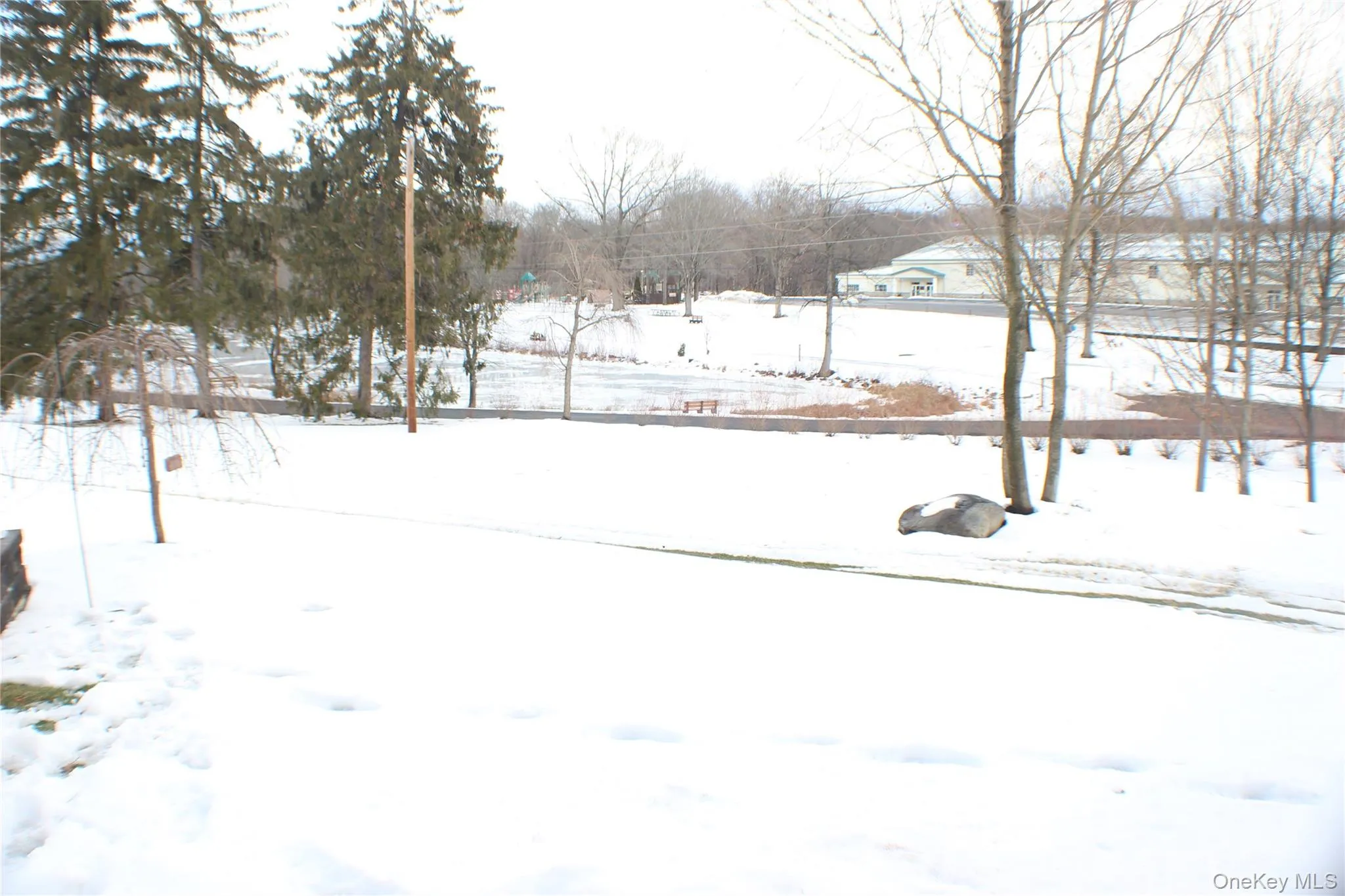 View of yard covered in snow View of yard covered in snow